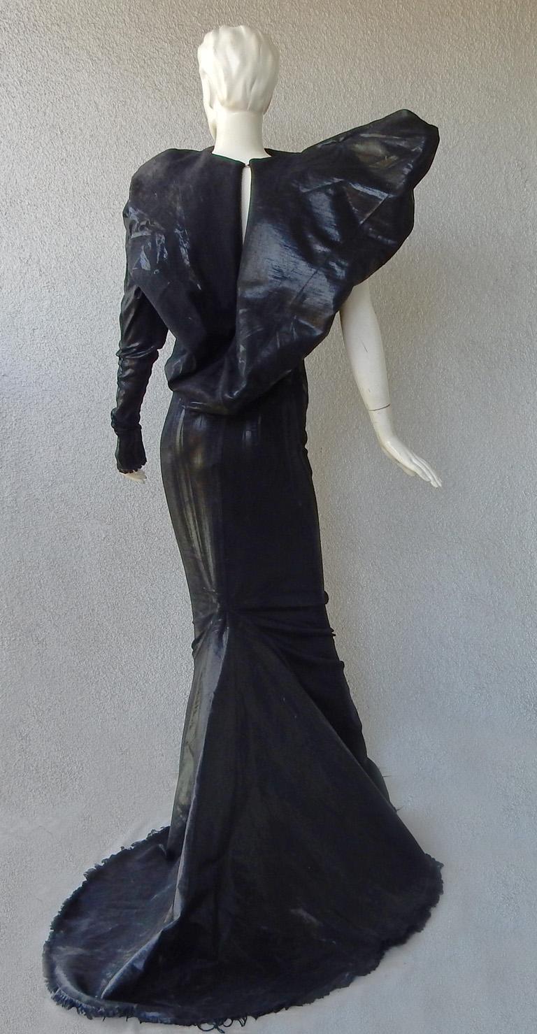 Rick Owens is known for his sculptural silhouettes and amazing mix of designs.   As seen on the runway this Rick Owens dramatic entrance maker.

A one-shoulder single sleeve evening gown in a coated finish fabric fashioned in a dramatic crease