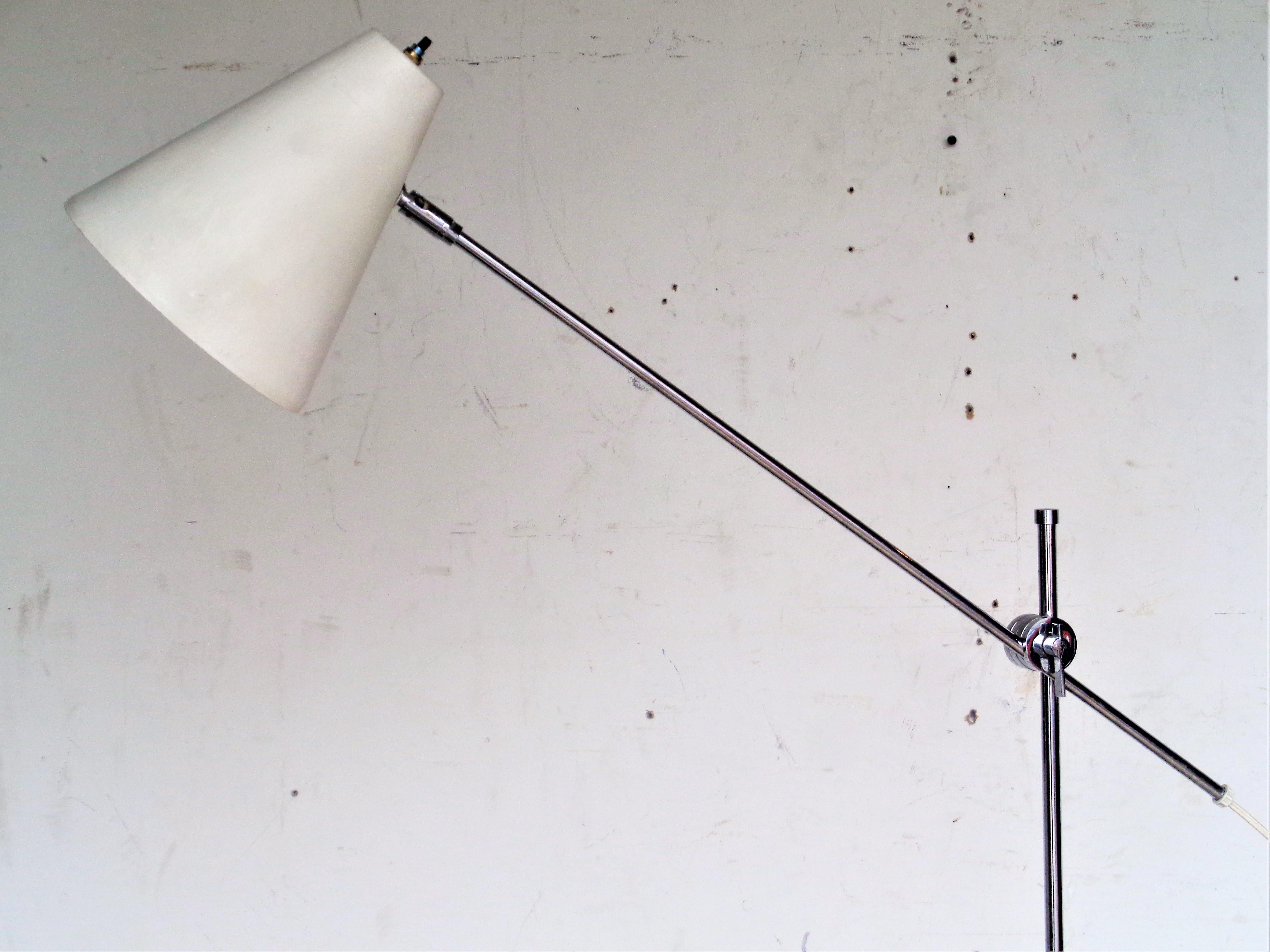 OMI floor lamp in chrome and painted metal with adjustable height armature and pivoting conical shade. Signed OMI on chrome knuckle below shade ( img. 9,10 ) Circa 1960. Measures 10 inches diameter at base with a maximum height adjustment of 72