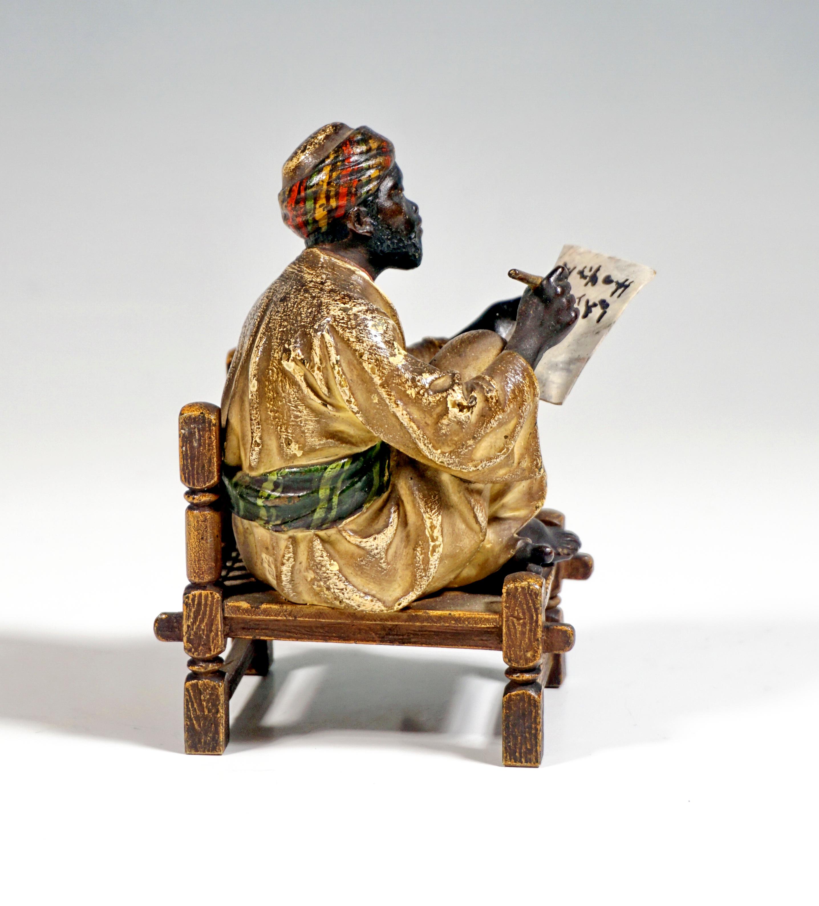Excellent Piece of Viennese Bronze Art around 1900:
A bearded oriental in a long light robe and turban sits cross-legged on a wooden bench and writes on a sheet of paper he holds in his left hand.
The figure is decorated in color, Bergmann signet