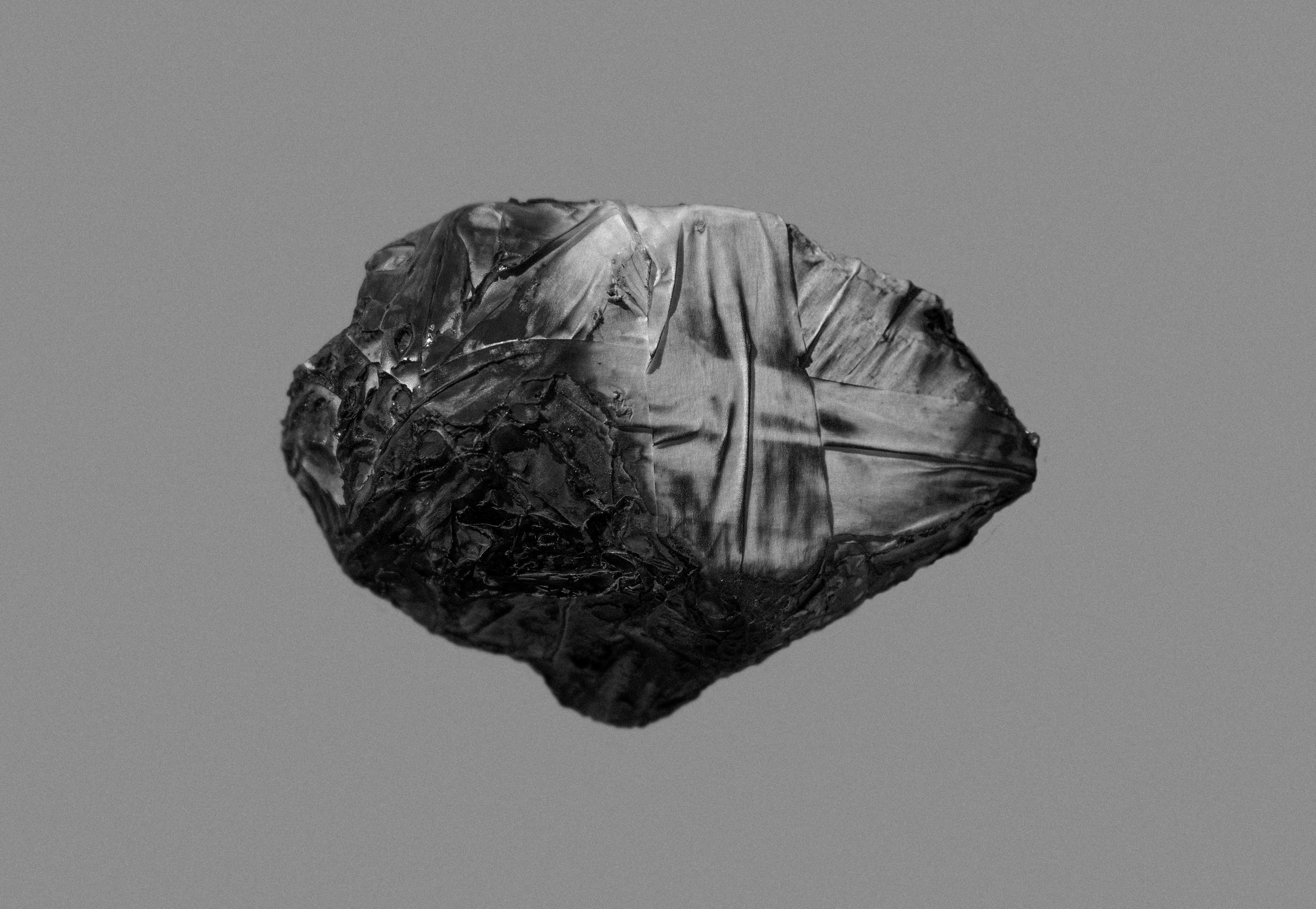 On Hansen Black and White Photograph - A rock cannot burnt to ashes. Abstract black and white photograph