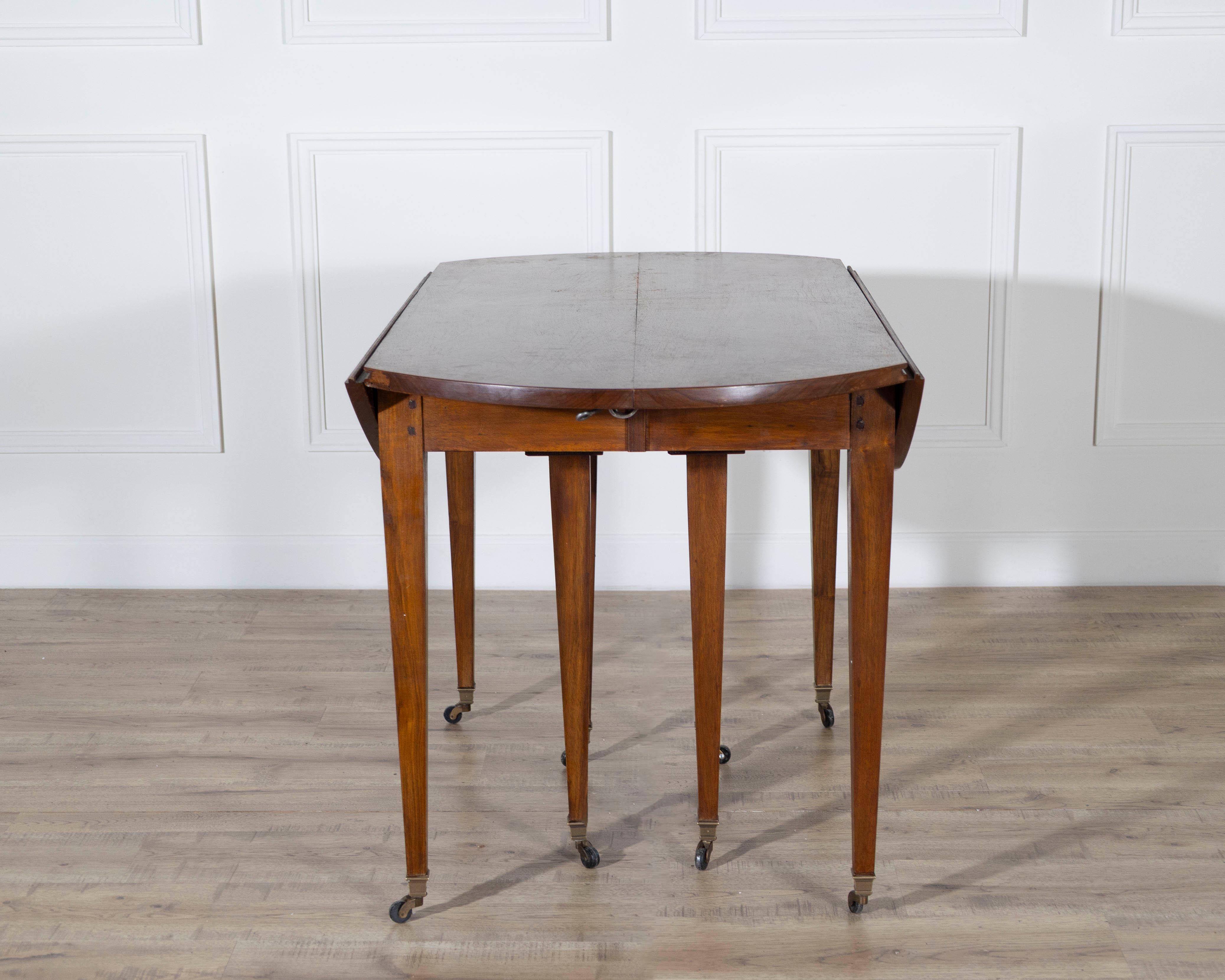 A beautifully crafted early 20th-century French extension dining table in the Restoration style, made from richly grained solid walnut. Measuring an impressive eight feet when fully extended, this elegant piece offers both grandeur and versatility —