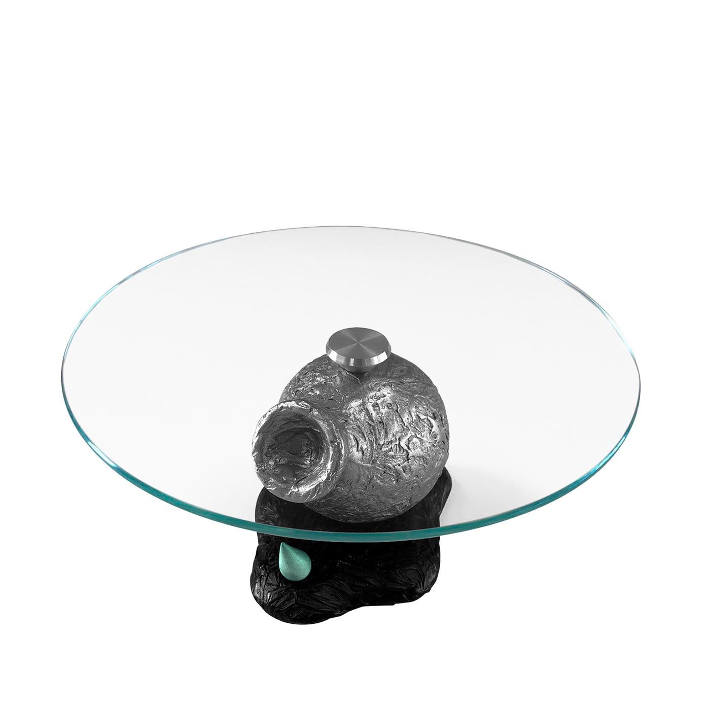 A spectacular hybrid between a table and a contemporary sculpture, this design is sure to take center stage in a modern dining room. A milled aluminum disk fastens the extra-clear tempered glass top to the milled volumes making up the base, finished