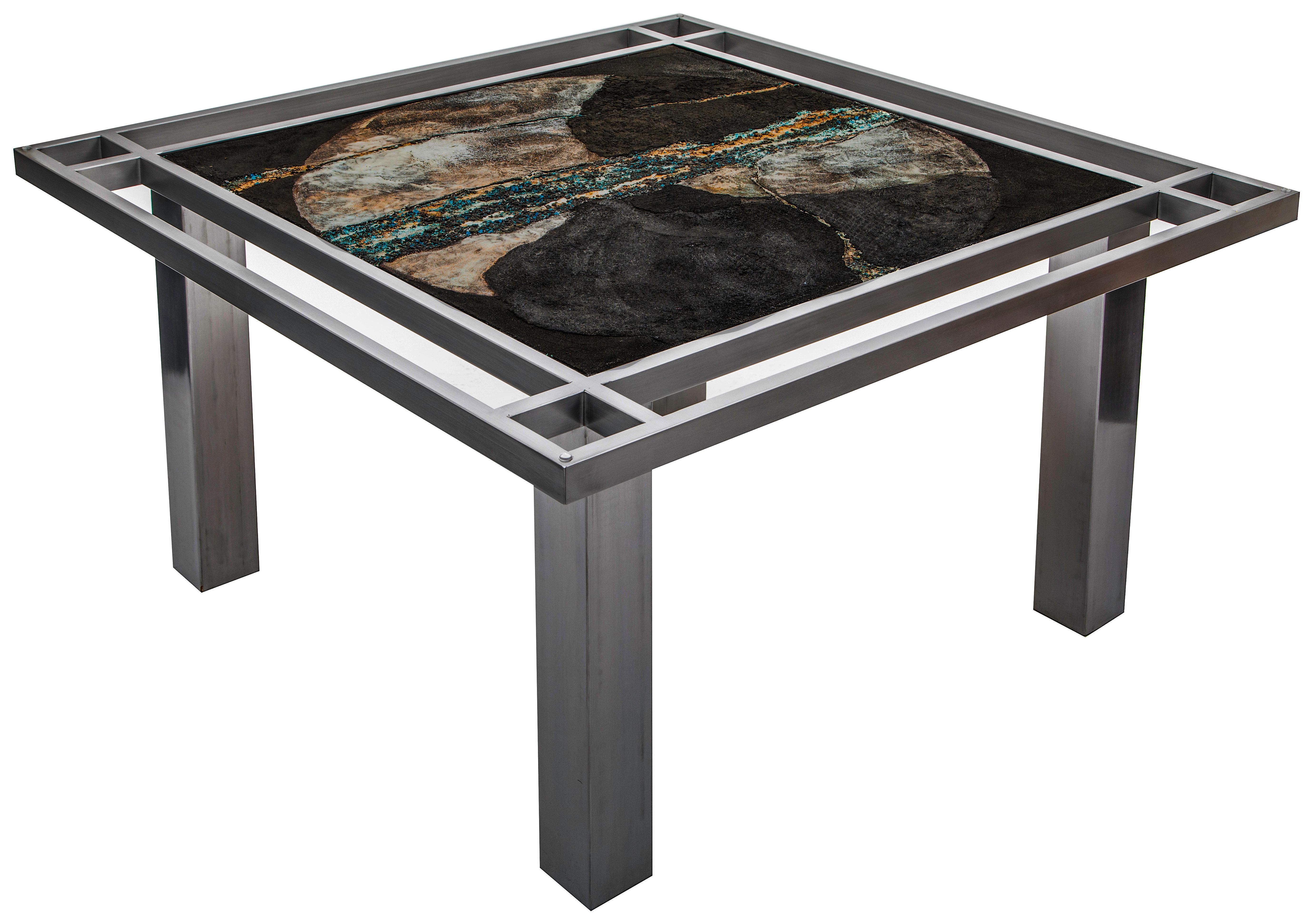“Once in a Blue Moon” is a one-of-a-kind table designed and manufactured by KalaRara. The tabletop is created on canvas using a palette applied composite of pulverised Ligurian black marble mixed with crushed obsidian which has been stamped with