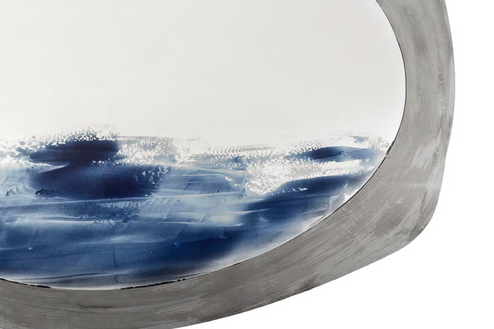 This mirror composition is the result of two-dimensional shapes
arranged in two different layers. front sheet: ultra white low iron 5 mm float glass, edge polished, hand painted with hand brushed blue ceramic enamels melted on the surface during the
