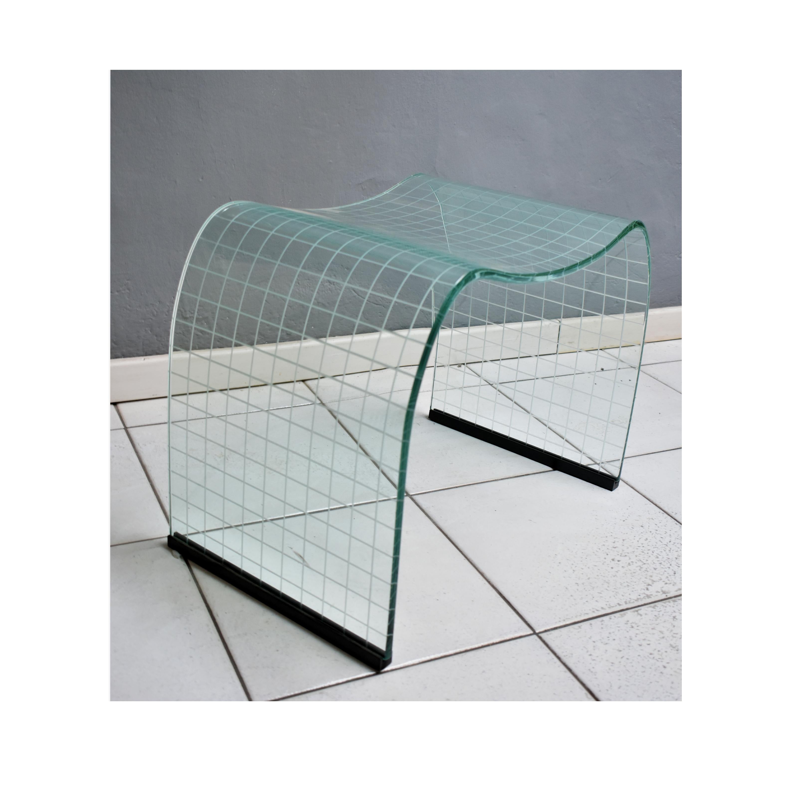 Onda incisa glass stool by Vittorio Livi for Fiam Italia, circa 1970s.
 Designed in 1973. Curved single sheet of glass with incised etched grid design. Curvaceous waterfall form. Original black plastic glides intact.
Very good condition.