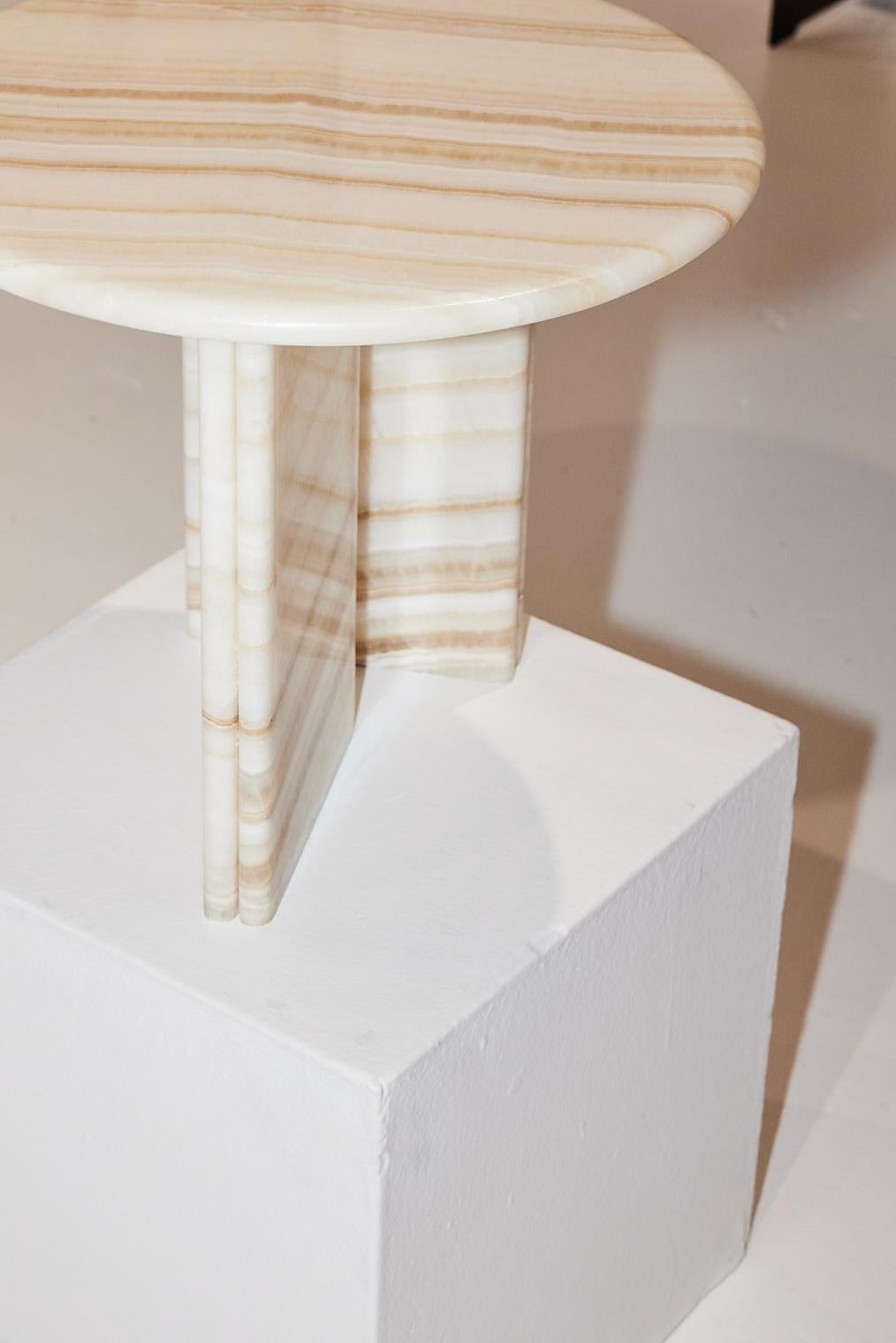 Onda Side Table in White Onyx designed by Just Adele.

The Onda Side Table is characterised by its soft forms and bold stone finishes. Translating to “wave” in Italian, the name Onda takes its cue from the double bullnose detail on the base and soft