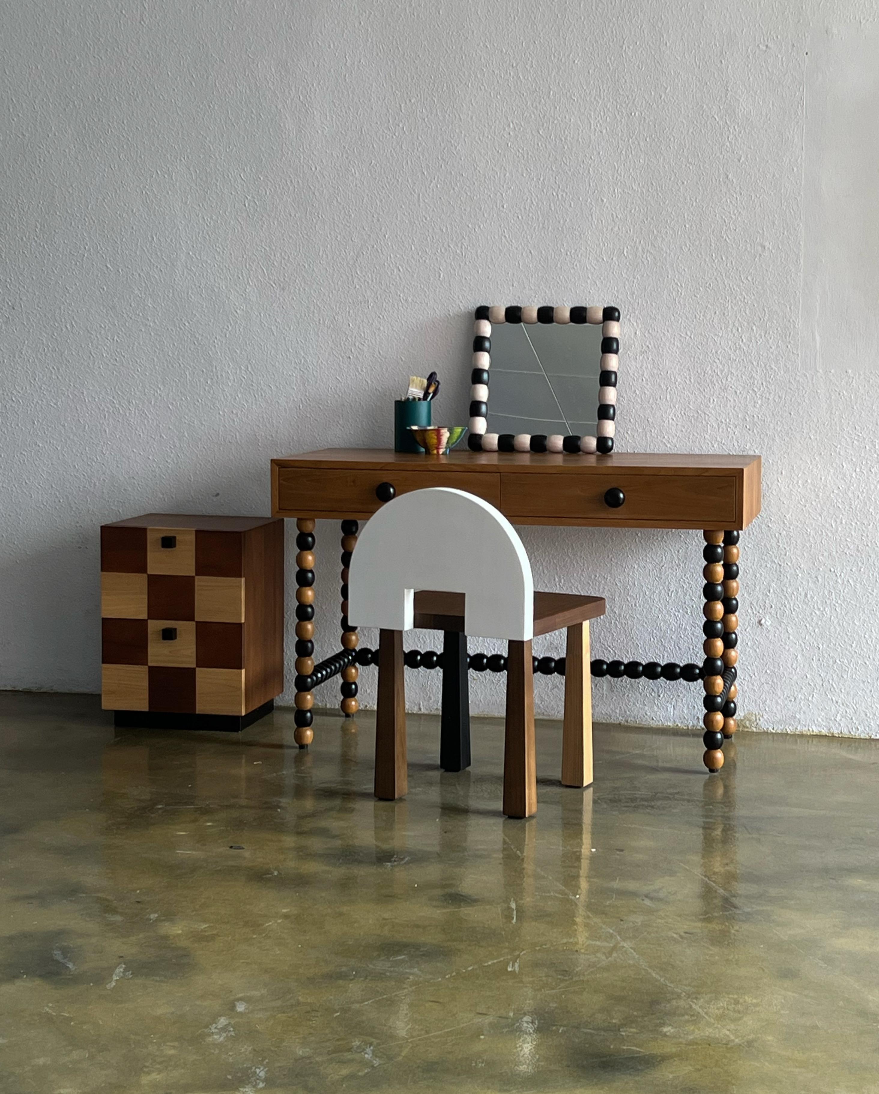 The Onde desk, designed by Studio Kallang in 2022, is a playful take on classic midcentury forms. Made in collaboration with generational artisans in Central Java, the desk is handcrafted from solid teak using traditional techniques and woodturning.