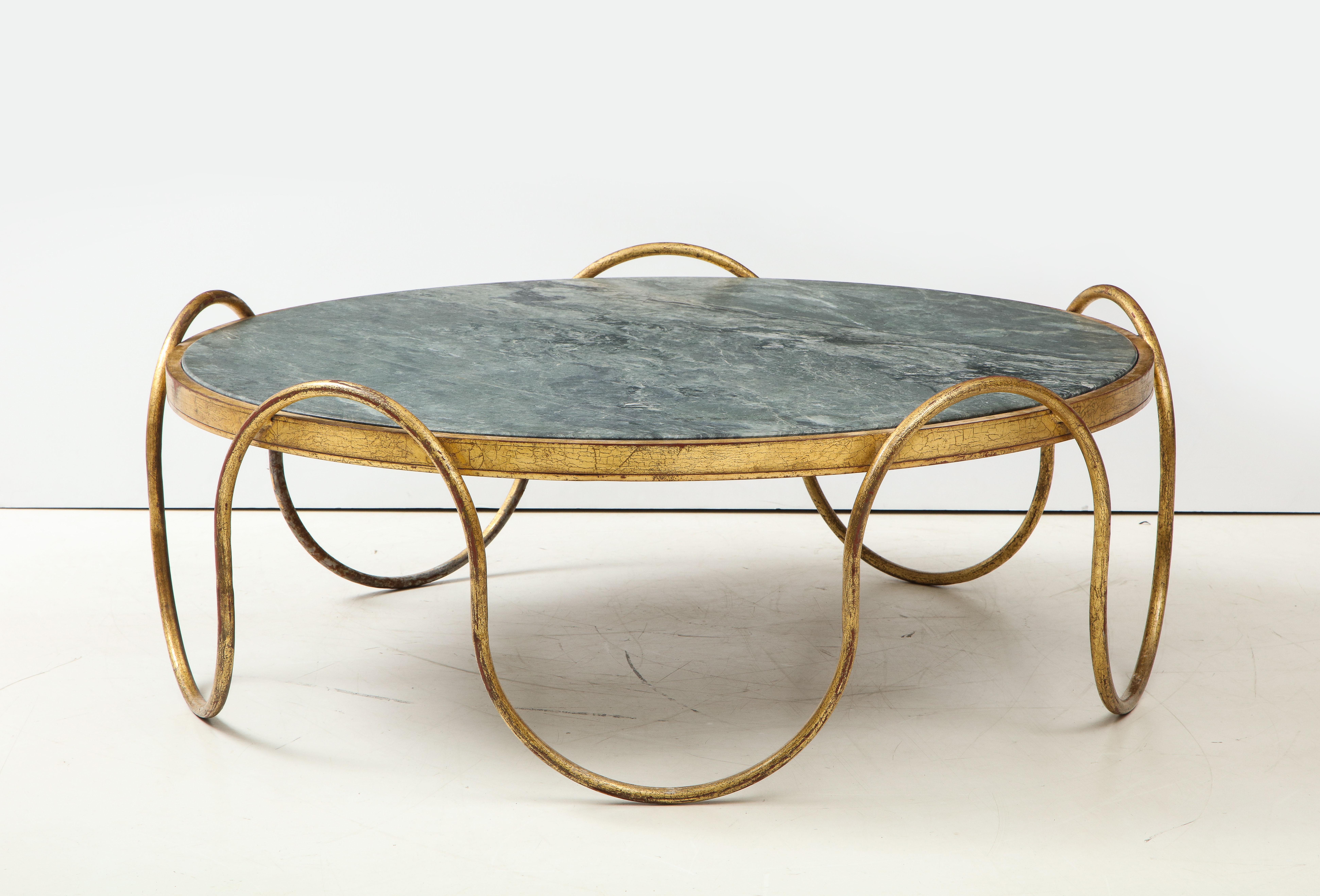 Ondulation coffee table.
The sinusoidal wave frame in gilded iron has a polished green leathered finish stone top.
The height to the top of the stone is 17