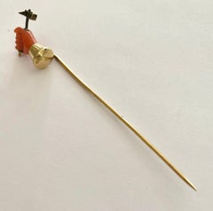 One '1' 14 Karat Gold Stickpin with a Coral Hand Holding a Hammer of Gold, 1890