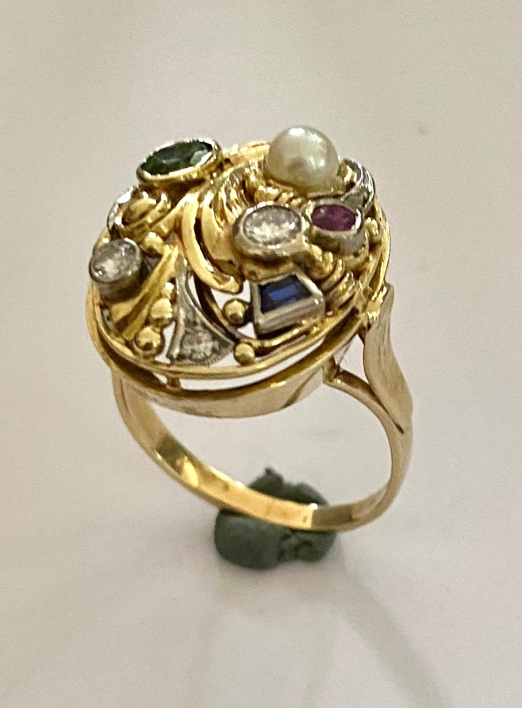 One (1) 14K. Yellow and White Gold Oval Cocktail Ring
set with:
4 diamonds, (Old European cut and single cut
1 oval mixed cut natural Vedelite (Tourmaline)
1 Roud mixed cut natural Ruby
1 Tapered Baguette batural Sapphire
1 Cultered Pearl (Akoya