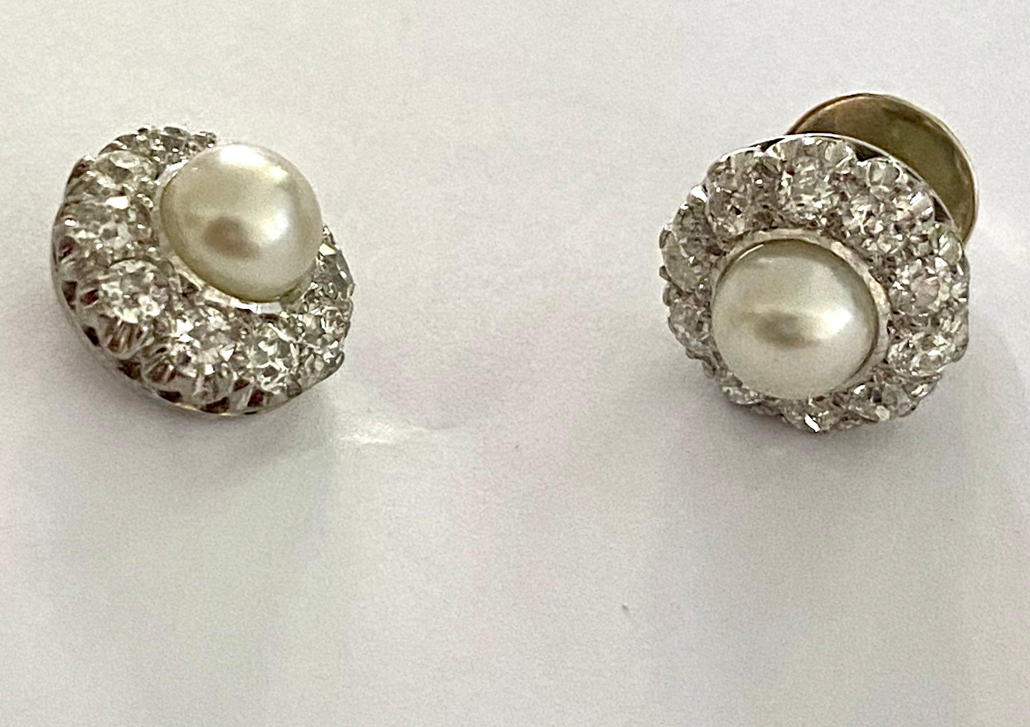 One (1) 14K. White Gold earrings 585/- model: Entourage
set with 2 bear round Cultured Pearls (Akoya) and  20 Old European cut natural Diamonds
Total Pearl weight: 3.83 ct.
Total diamond weight: 1.80 ct  Si  /F
Made in Holland ca 1920  (Dutch stamps)