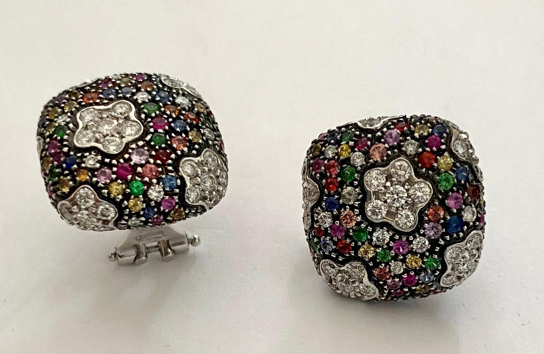 One (1)  pair of 18K. withe Gold earclips with gemstones and diamonds set.  
42 diamonds all kinds of small saphires in all collours  and 6 tsavorithes (each clip)
Signature: *690AL=  Lani, Fratelli  s.r.l., Viale Dante 13, 15048