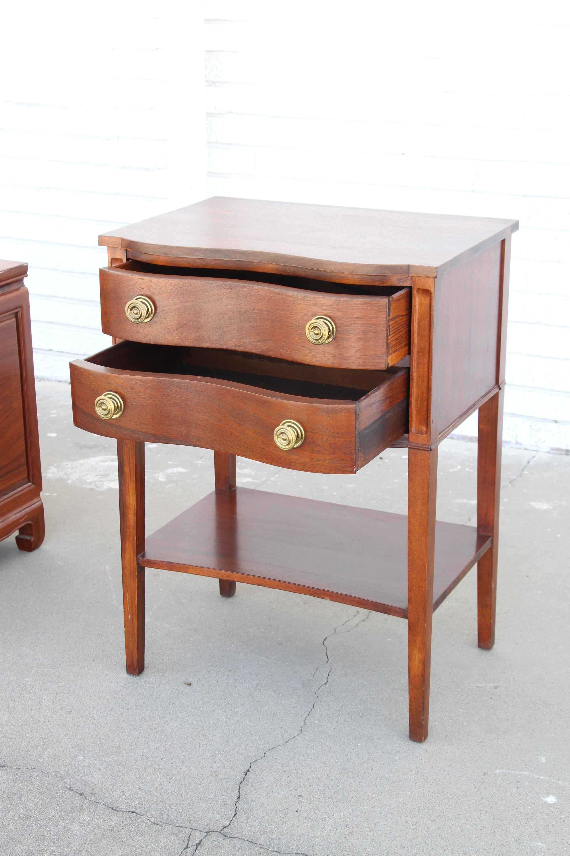 One Chippendale Mahogany Serpentine Front 2-Drawer Side Table

Chippendale mahogany serpentine front 2-drawer side table.  Brass pulls. Open shelf below. Very good condition.
 
Height: 28in 
Width: 20.5in
Depth: 15in