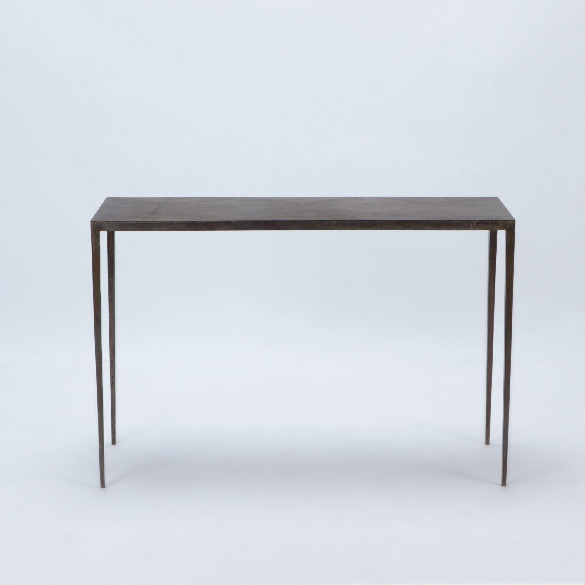 A wrought iron console with bronze wash and slender matte black wrought iron bases. In the manner of Jean-Michel Frank. Contemporary.