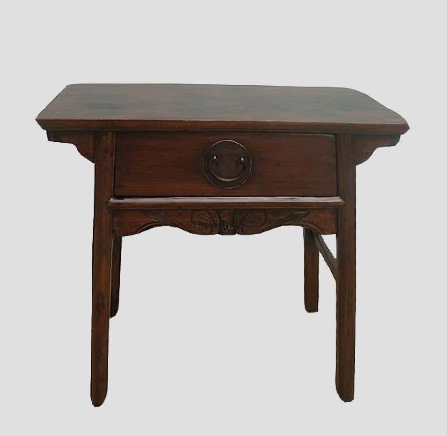 With the original wood color finish, carved front apron, unique round brassware, this over century old antique side table adds delightful Asia flair to any room.