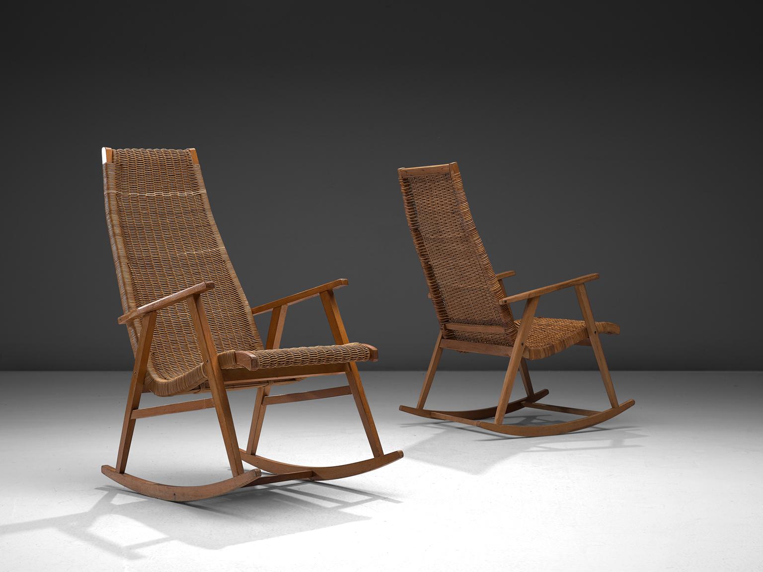 One lounge chairs, in cane and wood, The Netherlands, 1950s.

The Dutch rocking chair feature a simplistic, functional frame. The back of the chair however is unusually long giving this comfortable chair a certain grandeur and stateliness. The