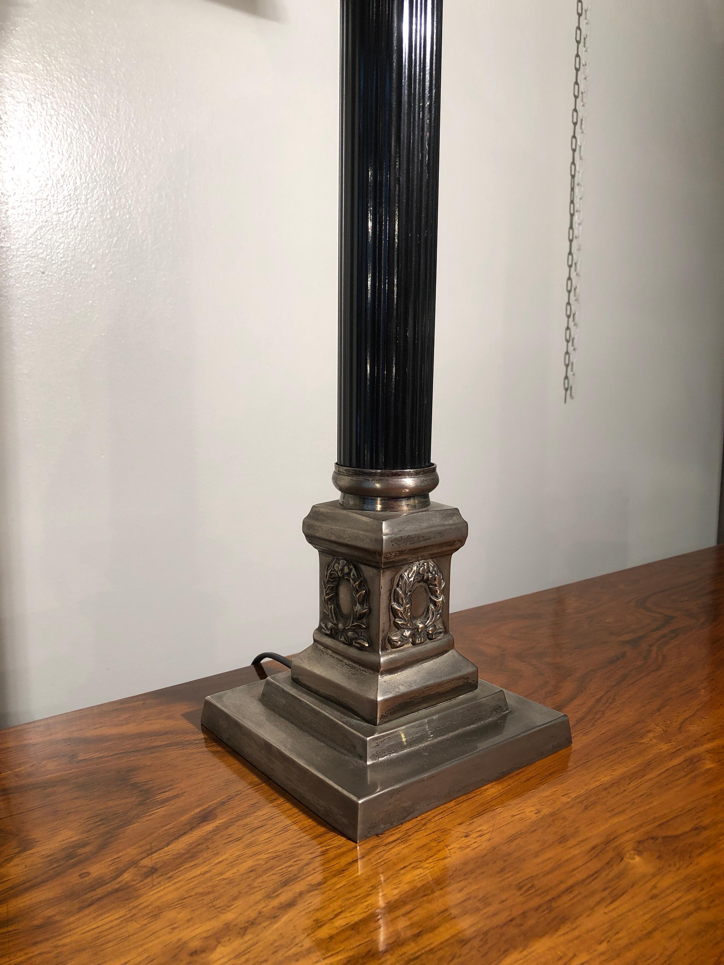 Empire style silvered and black engraved metal table lamp, France, early 20th century, 1930s

In the pictures you see two lamps but only one left.

Table lamp with metal black lacquered central metal body and finely engraved silvered endings.