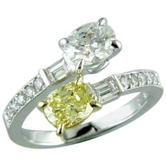 One Fancy Platinum Swirl Yellow and White Oval Diamond Ring