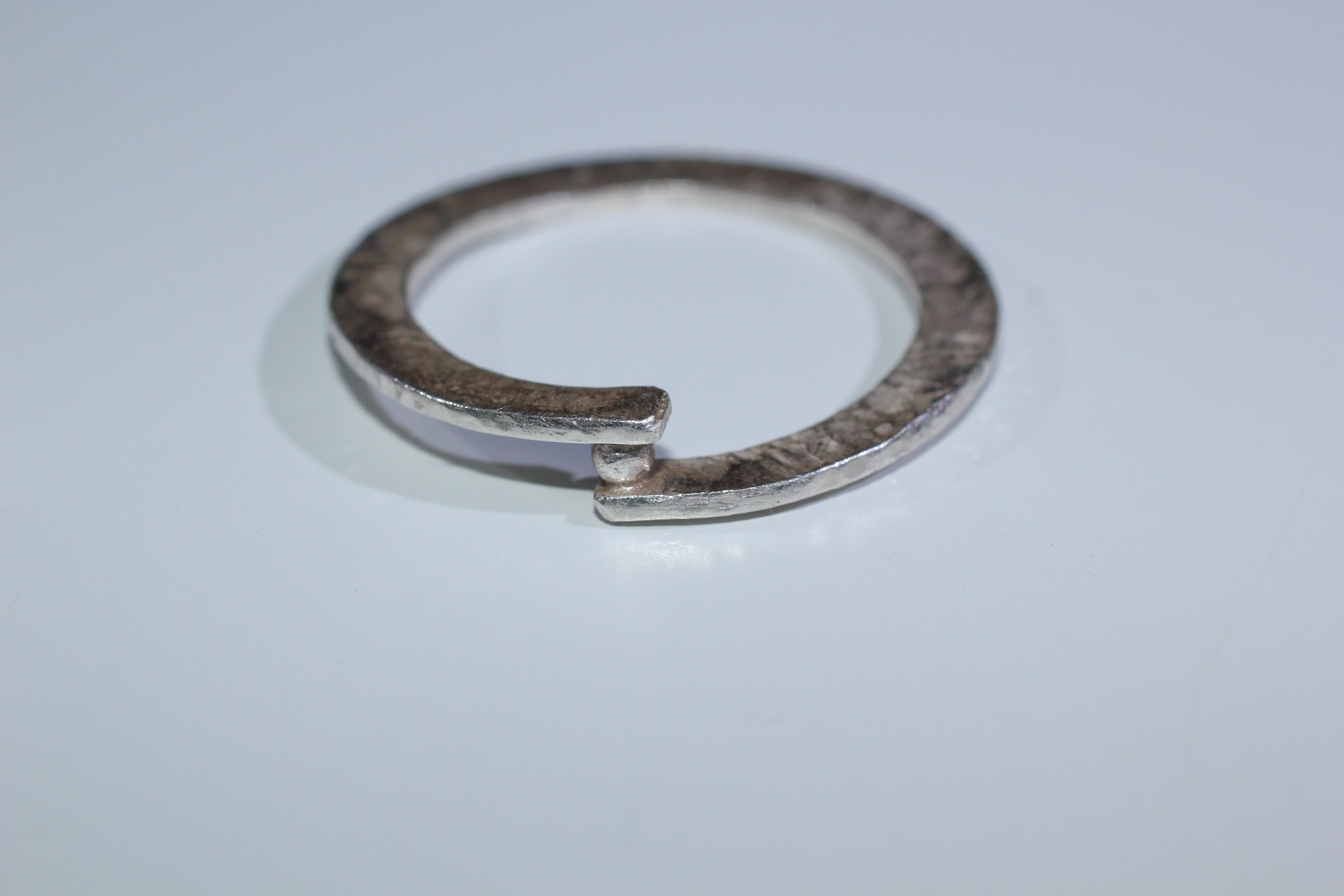 Simplicity With A Twist Holding One Granule, contemporary design.

This listing is for a fashion ring in sterling silver, measuring 1mm wide by 3mm thick.

Process: This striking ring is first hand forged in 21k gold, then cast in various metals and