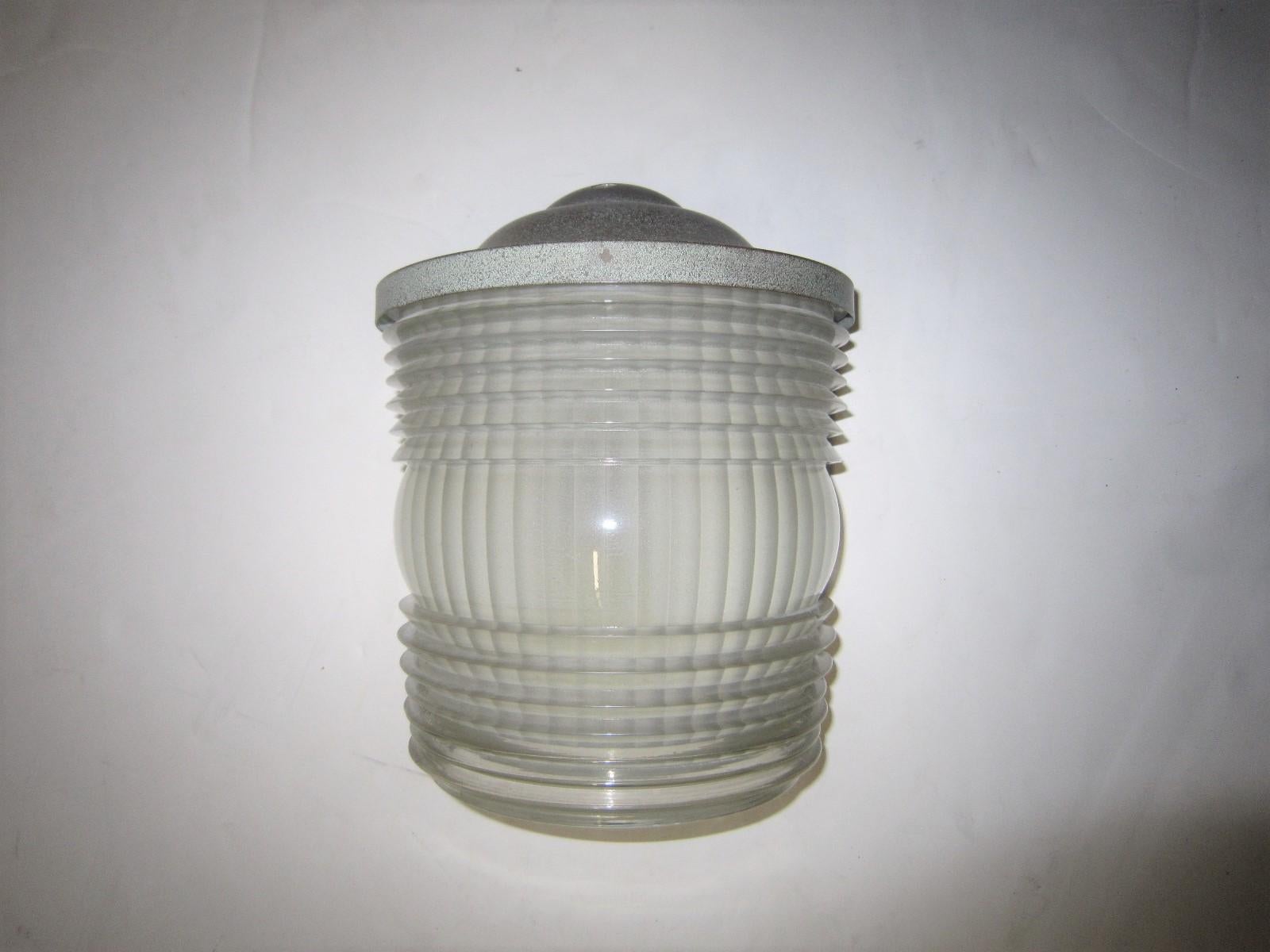 A single original Art Moderne semi-cylindrical sconce spotlighting a heavily molded polished art glass sheath
with linear pattern and original mounts. Signed by the maker J. Perzel
French Modernist and highly architectural with clean lines,