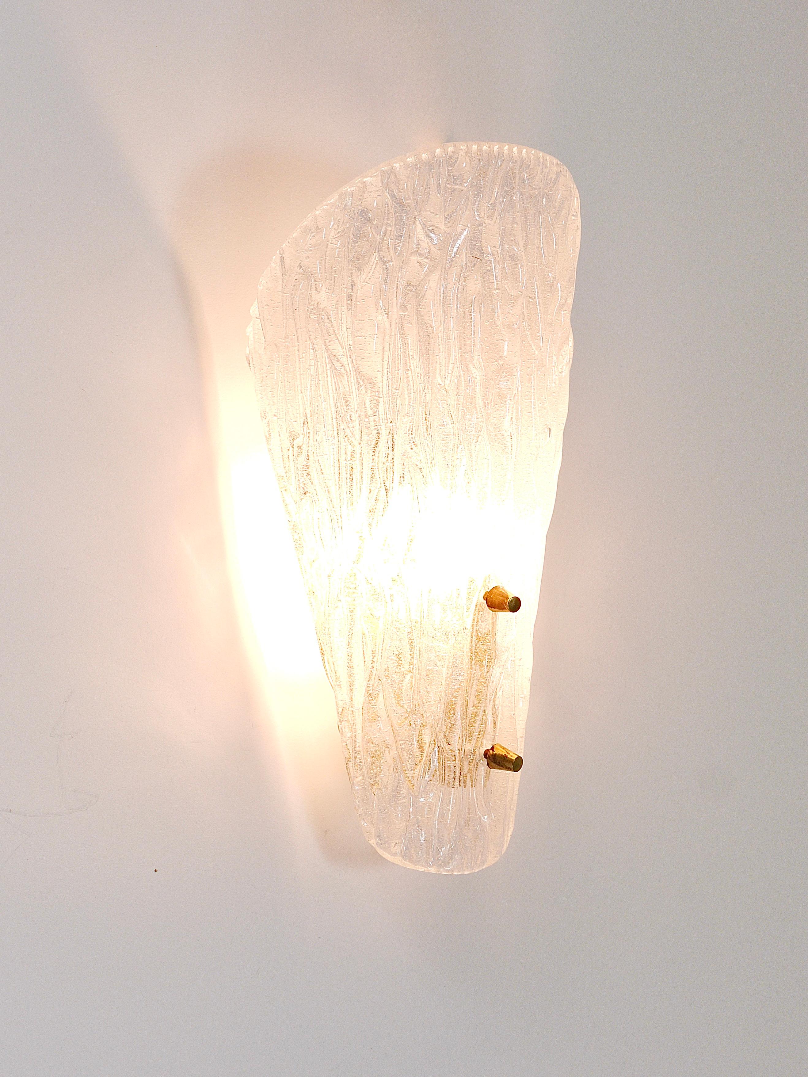 A single beautiful brass wall light with a lampshade made of solid textured melting ice glass with nice knobs. Manufactured by J. T. Kalmar Vienna in the 1950s. In very good condition with patina on the brass. Measure: height 11 inches, 5 inches
