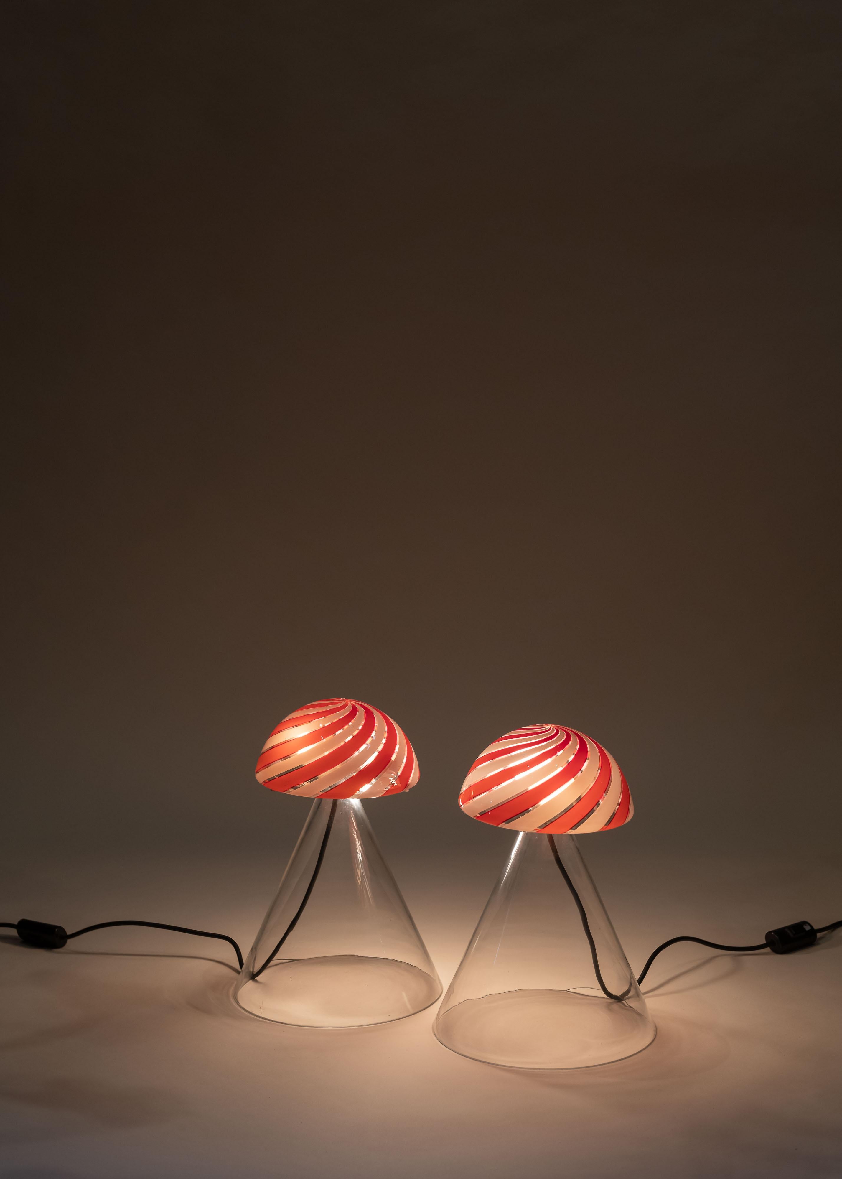 Whimsical yet sculptural, this Murano table lamp by Mazzega of Italy feature clear glass base and swirling two-tone striped glass diffuser. Great addition to bedside table, credenza or entry table. We have only one lamp.