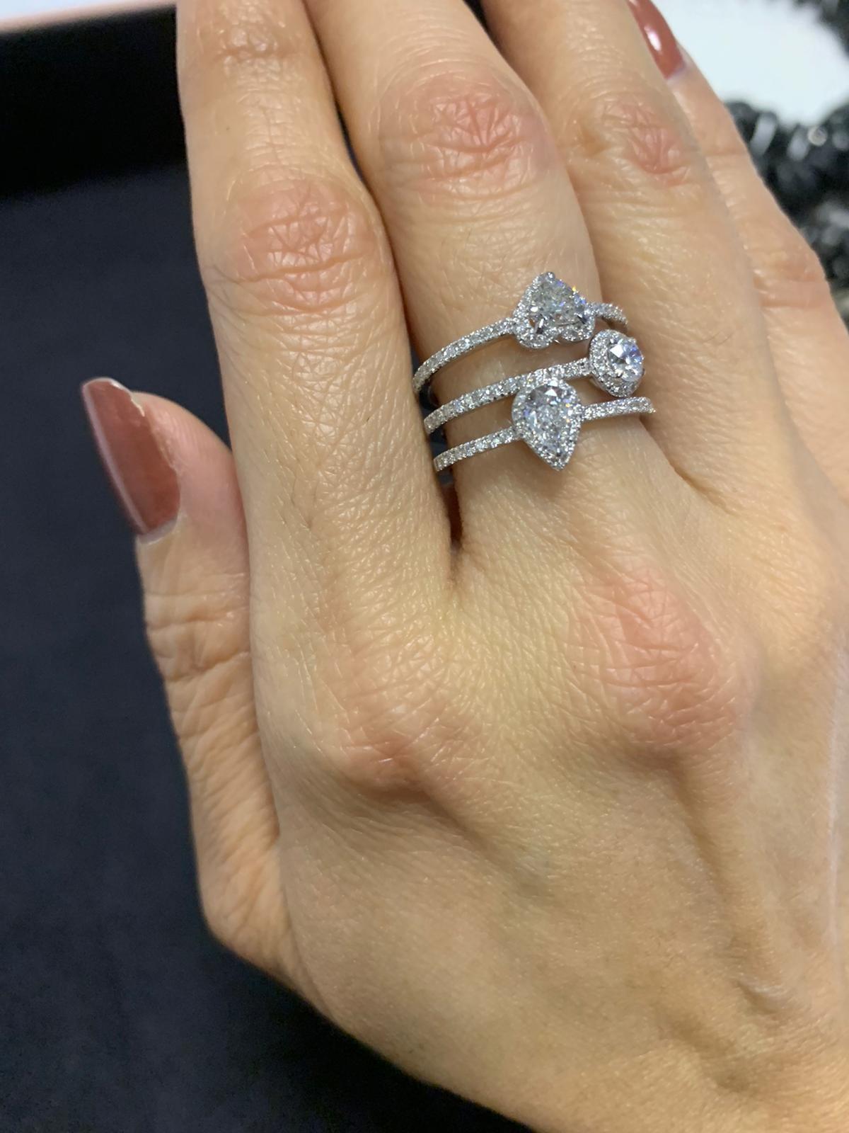 This beautiful handmade Solitaire Trilogy ring made in 18K White Gold and set with White Diamonds weighing 1.20cts is a timeless piece of jewelery, it's stylised design and three pure lines echo the Art Deco movement, each set with a primary