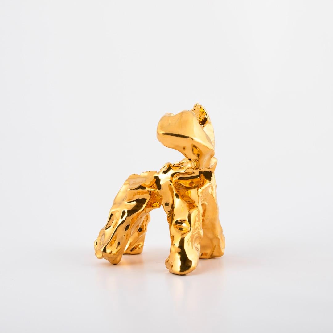 One-Minute-Sculpture. the name says it all!. 
The one-minute-sculpture is made of clay, coated with a gold luster. 

From inspiration during playtime with Marcel’s daughter, Joy, comes iconic handmade objects created in the timeframe of just one