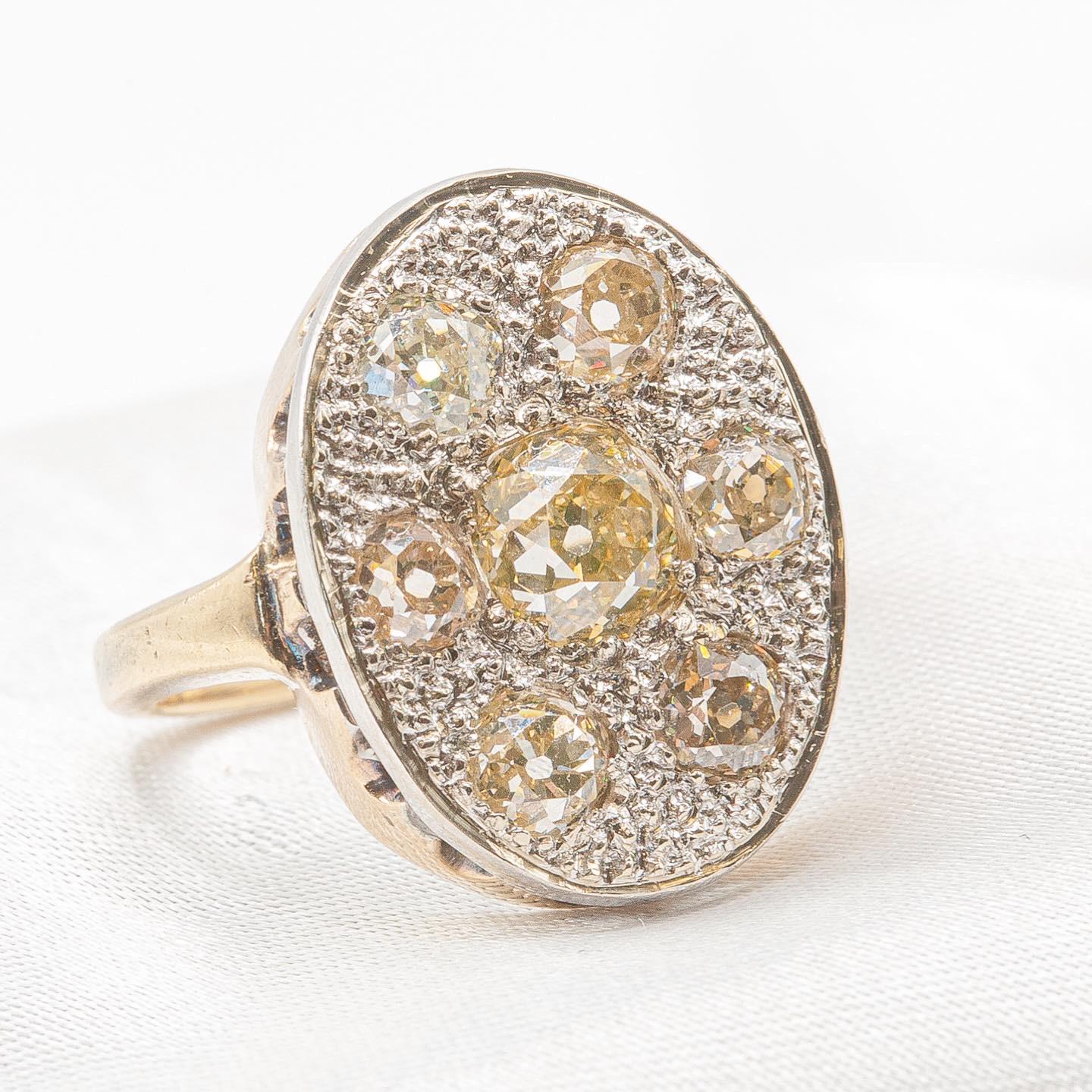 Very unique and beautiful antique old mine cut diamond ring in 10K white and yellow gold, sized at 5.25 with resizing available. This striking piece features approximately 2 carats of old mine cut diamonds in a rich brown color, with exceptional