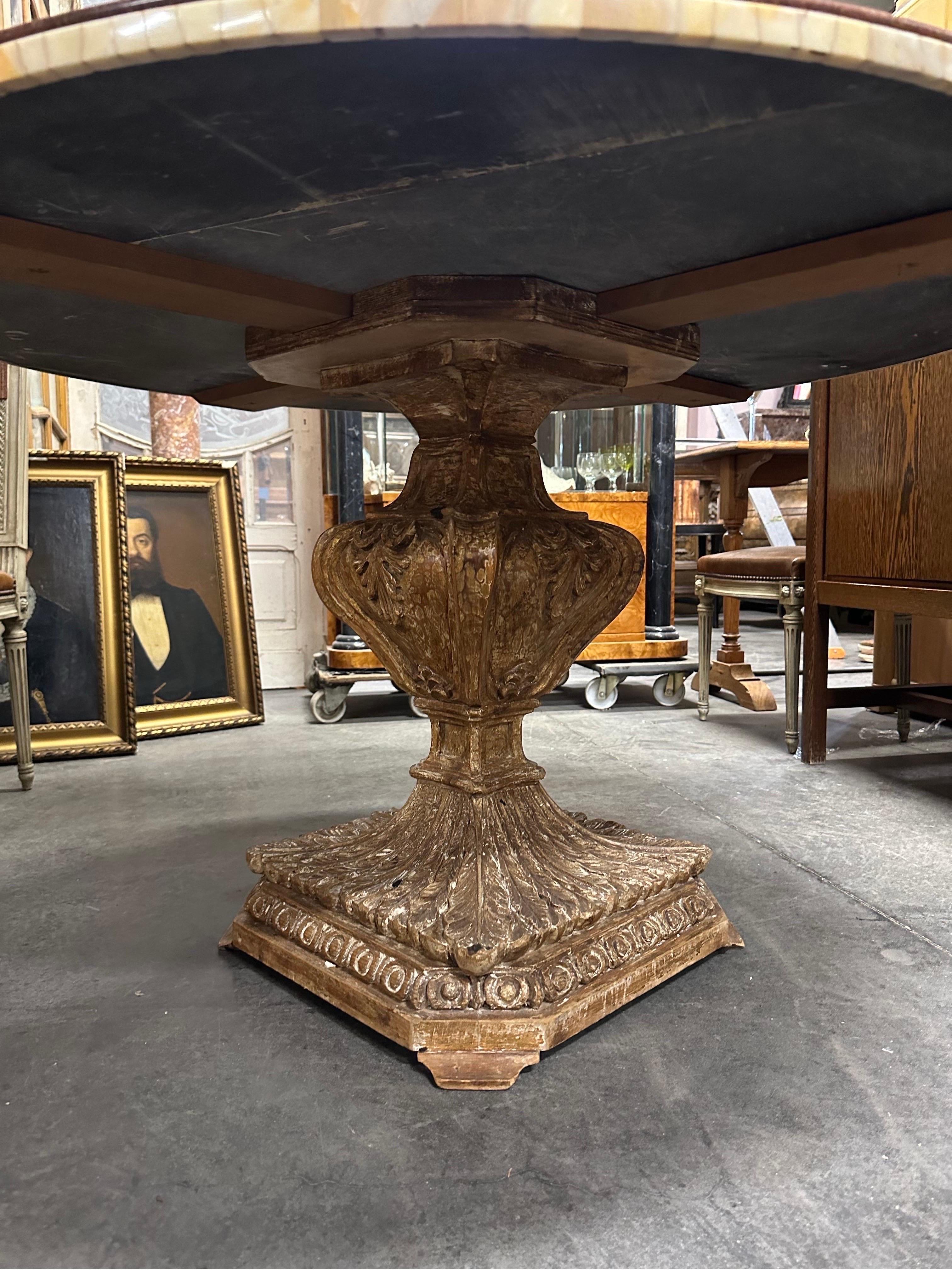 A very unique early 20thC Italian table with intricate marble top. The giltwood base showing fantastic patina. The marble top is a work of art. Fine pieces make up the rim. 
