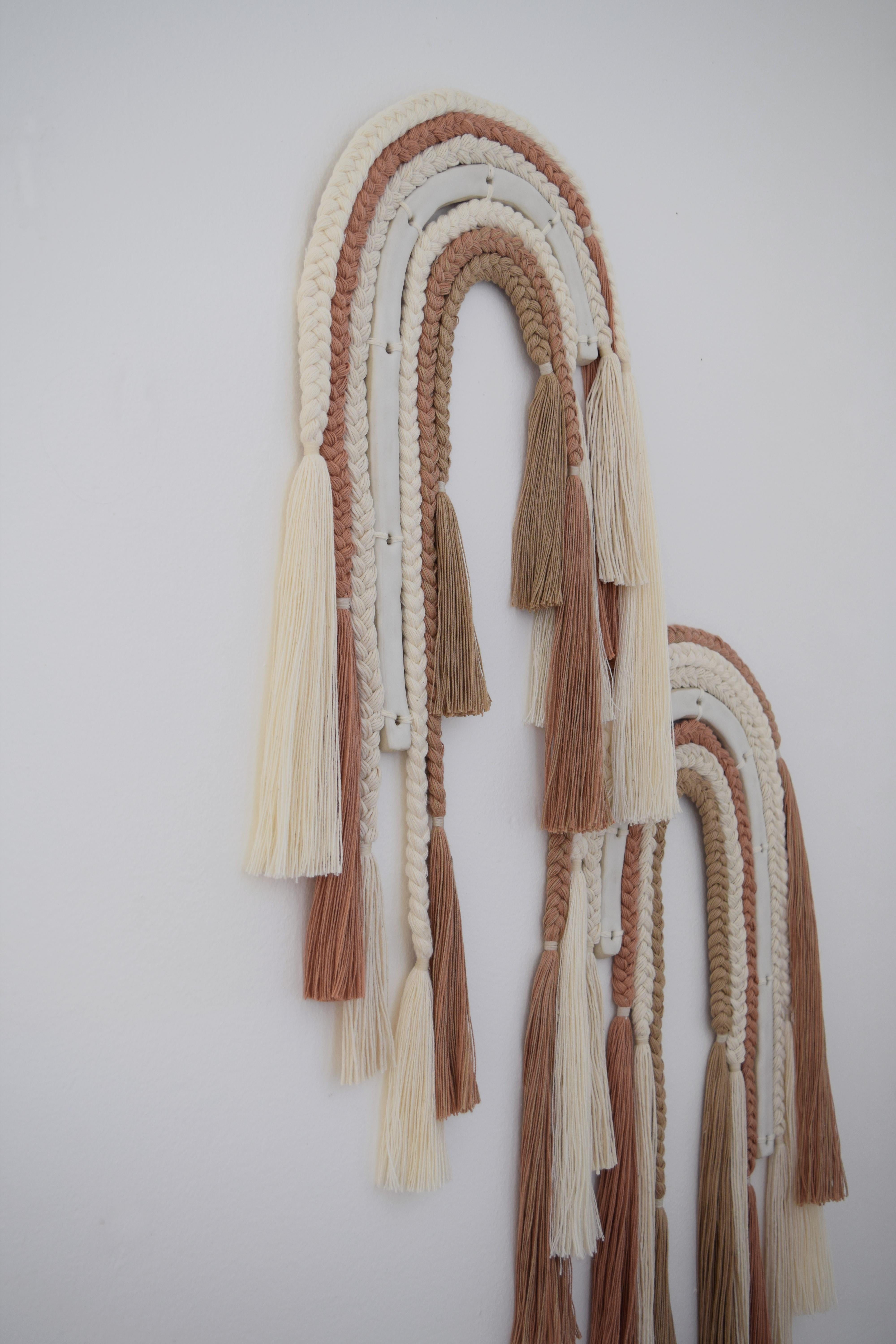 One of a kind wall sculpture #654 by Karen Gayle Tinney

One of a kind two-panel wall sculpture. Hand formed ceramic arches are finished with satin white glaze and surrounded by layers of braids in varying weights of cotton. The cotton braids are