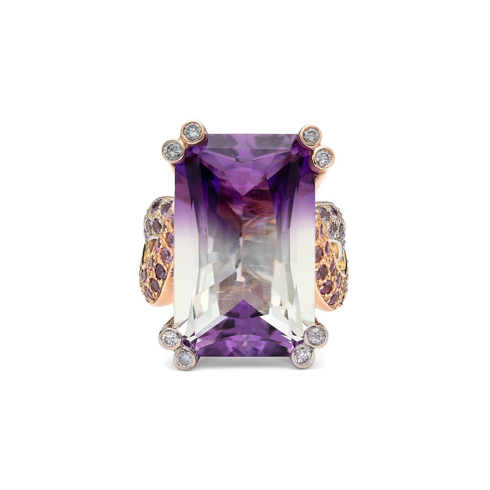 This natural Purple and White Bi-color Amethyst Ring is over 20cts set in a 18K rose and white gold handmade custom mounting with .65cts of pink and purple sapphires with .08cts white diamond tips. On-of-a-kind must add t0 your collection