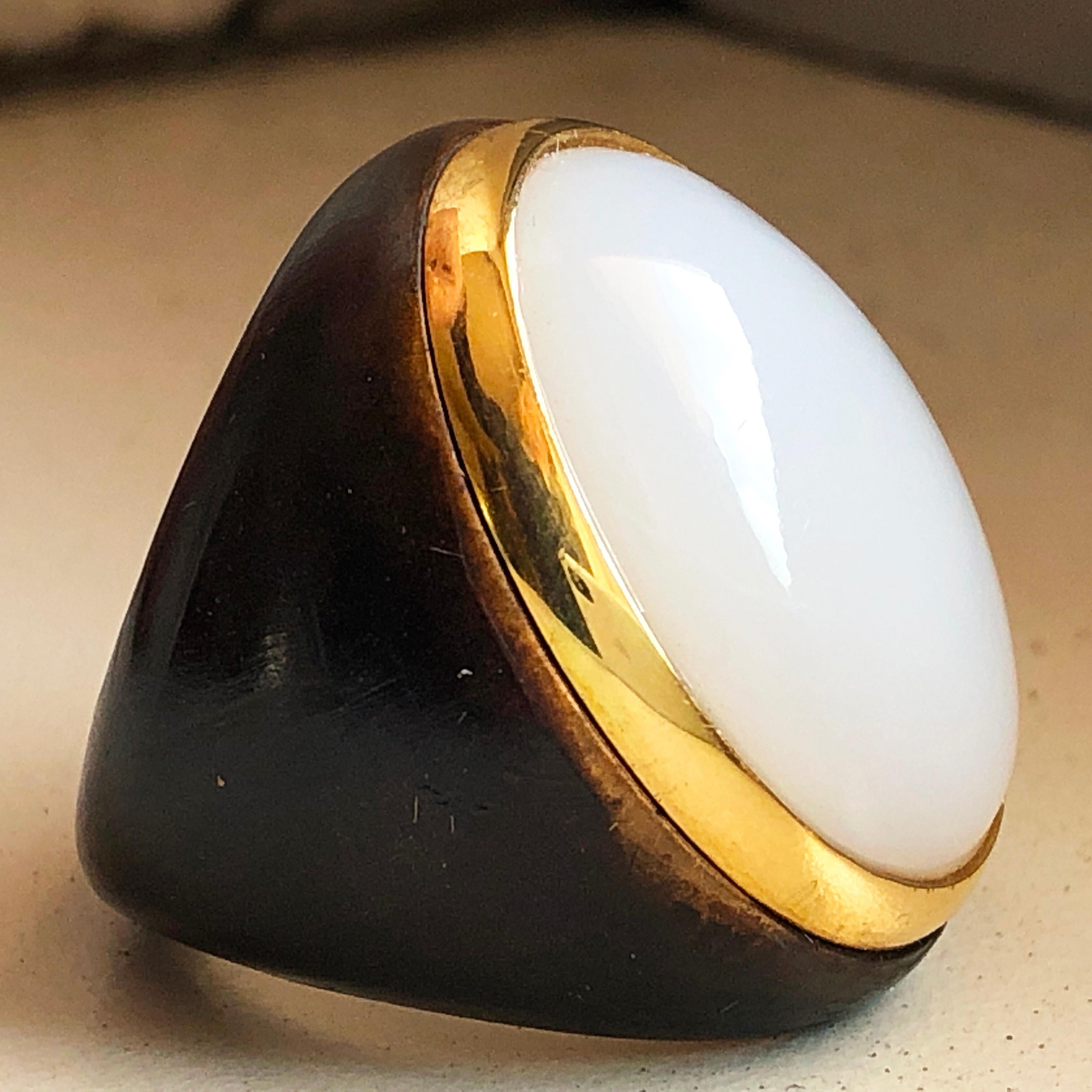 One-of-a-kind Contemporary Cocktail Ring Featuring a 20 Carat Natural White Opal Cabochon (0.911x0.666in) in an 18K Yellow Gold Brown Oxidized Brass Setting.
The color-changing of the White Opal's cabochon combined with the gold and brown brass