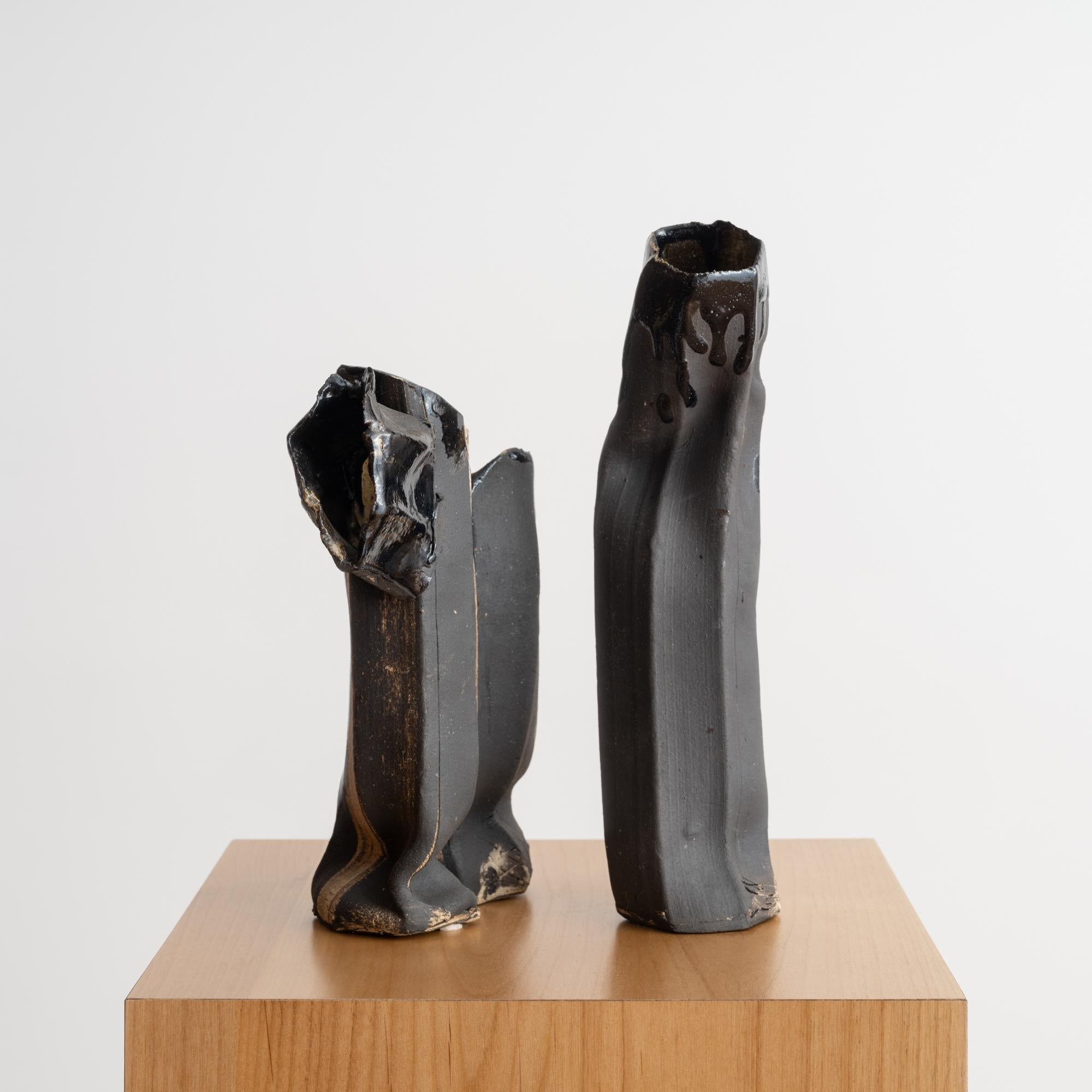 This unique sculptural vase is comprised of two hand-built ceramic components that fit together to create one visually arresting work of art that sustains the viewer's interest. Diminutive in scale, and dynamic from all angles, the piece is sculpted