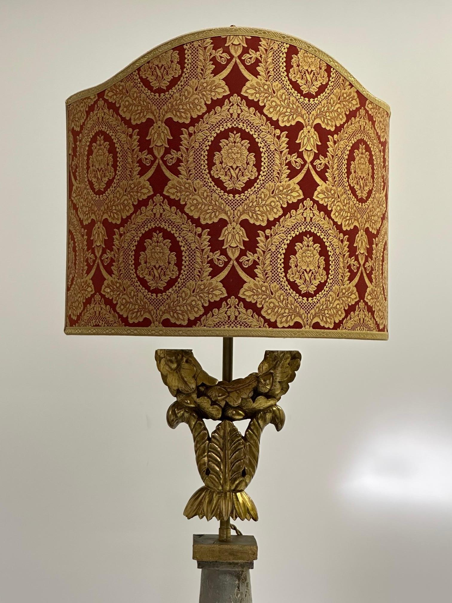 Very unusual cleverly made and artful French tall table lamp assembled from antique fragments of giltwood, painted wood and brass. The shade is custom and the lamp is french wired with silk cord.
Measures: shade is 16 W 13.5 H 7.5 D.
lamp itself