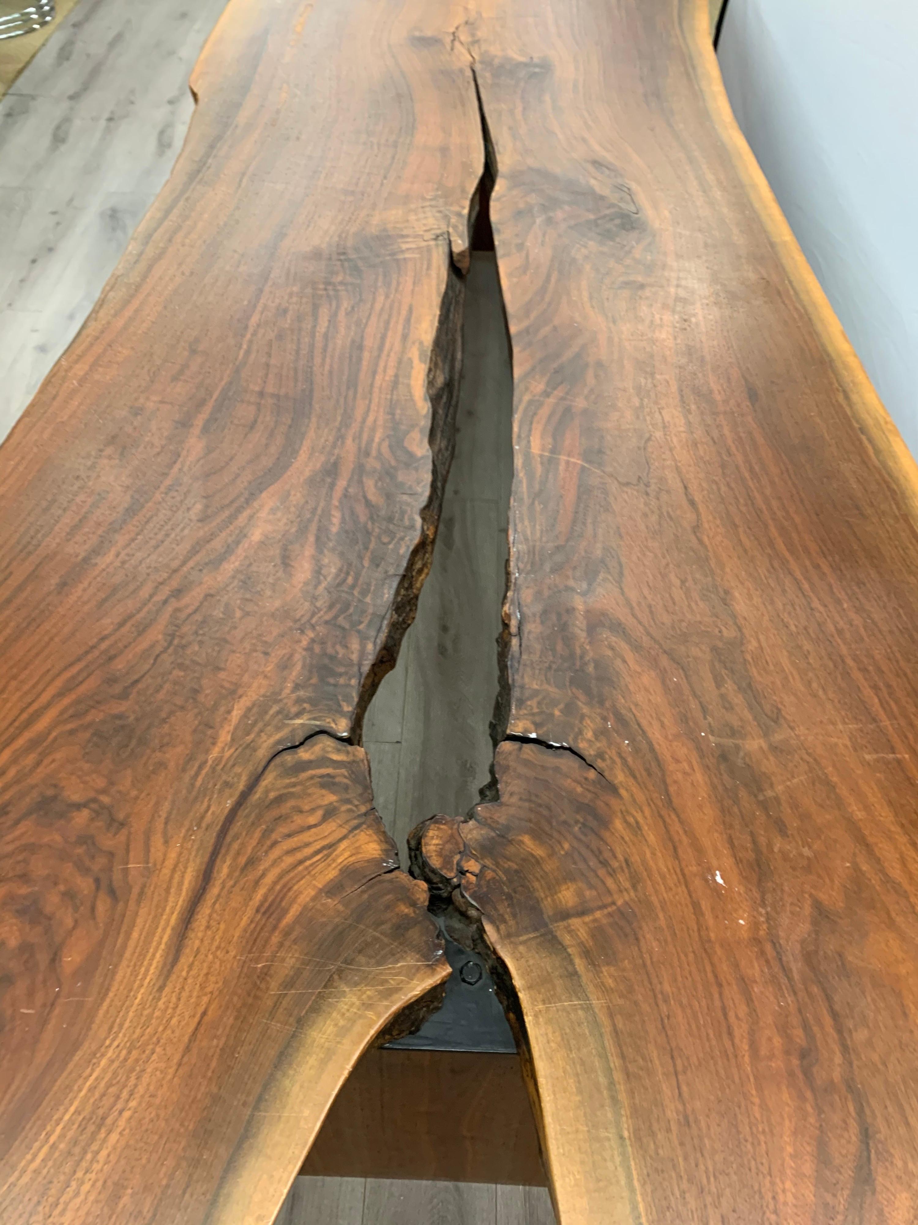 Gorgeous one of a kind custom live edge dining room table. An architectural gem. Great scale and better lines. The wooden slab is 2.5