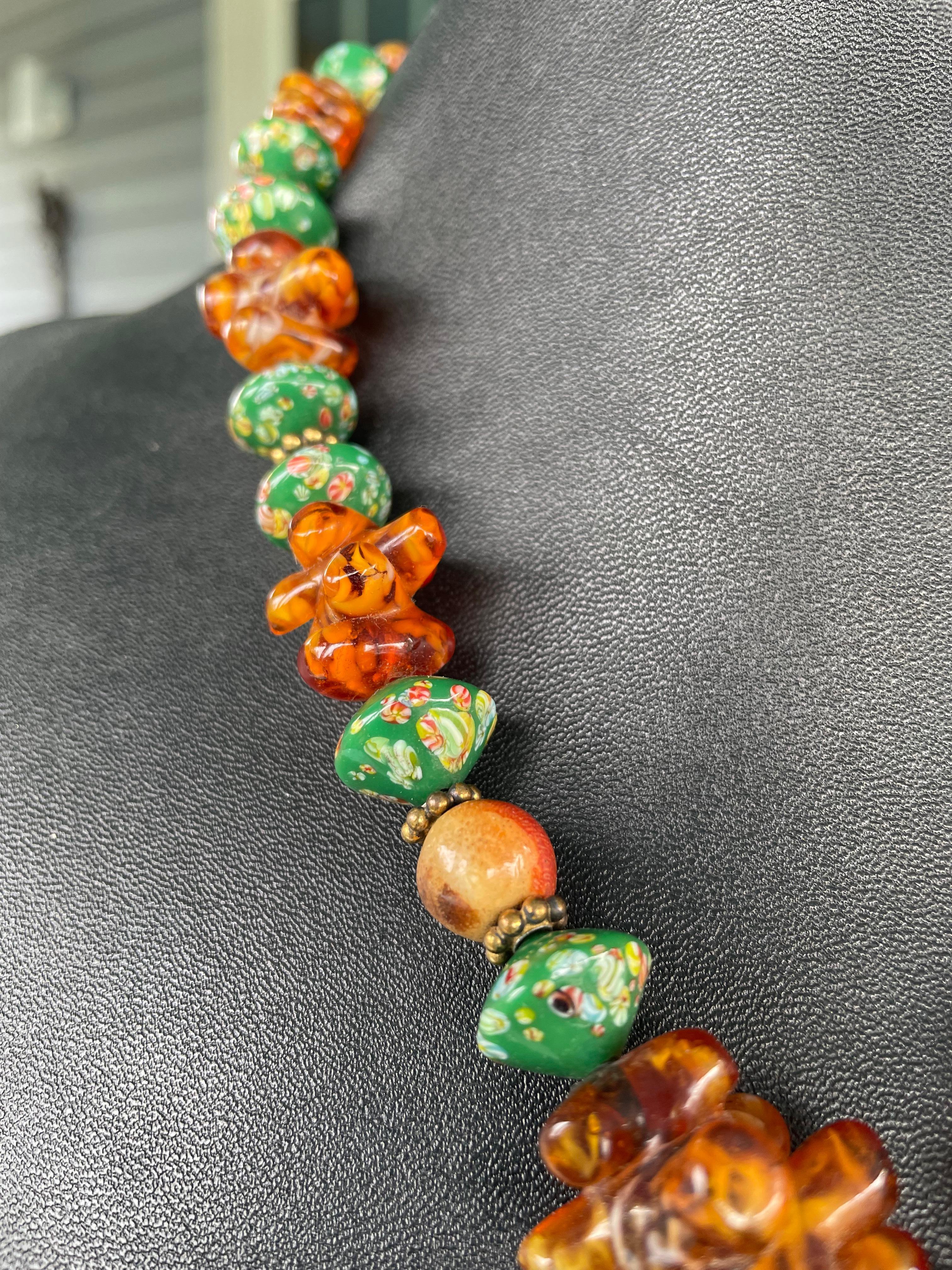One of a kind,handmade,statement,Bakelite and vintage glass necklace is offered from Lorraine’s Bijoux. Antique French glass beads,crabapple coral, Venetian trade beads,and vermeil spacers make up this piece.