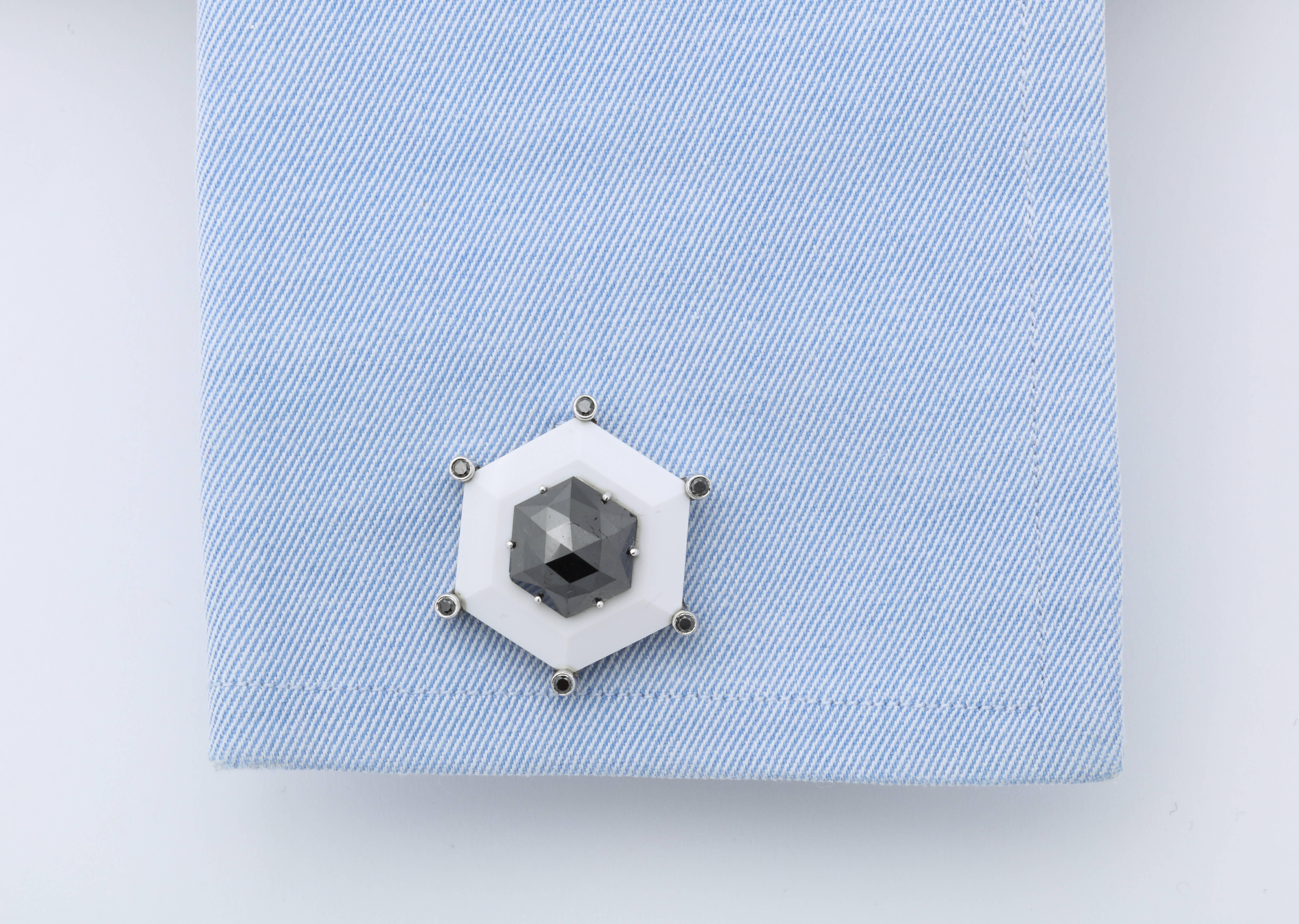 These completely bespoke cufflinks feature custom cut hexagonal black diamonds (2.96cts & 2.60cts) centrally set above white agate framed with bezel set round black diamonds.  The back of the cufflinks are also set with a pair of hexagonal black