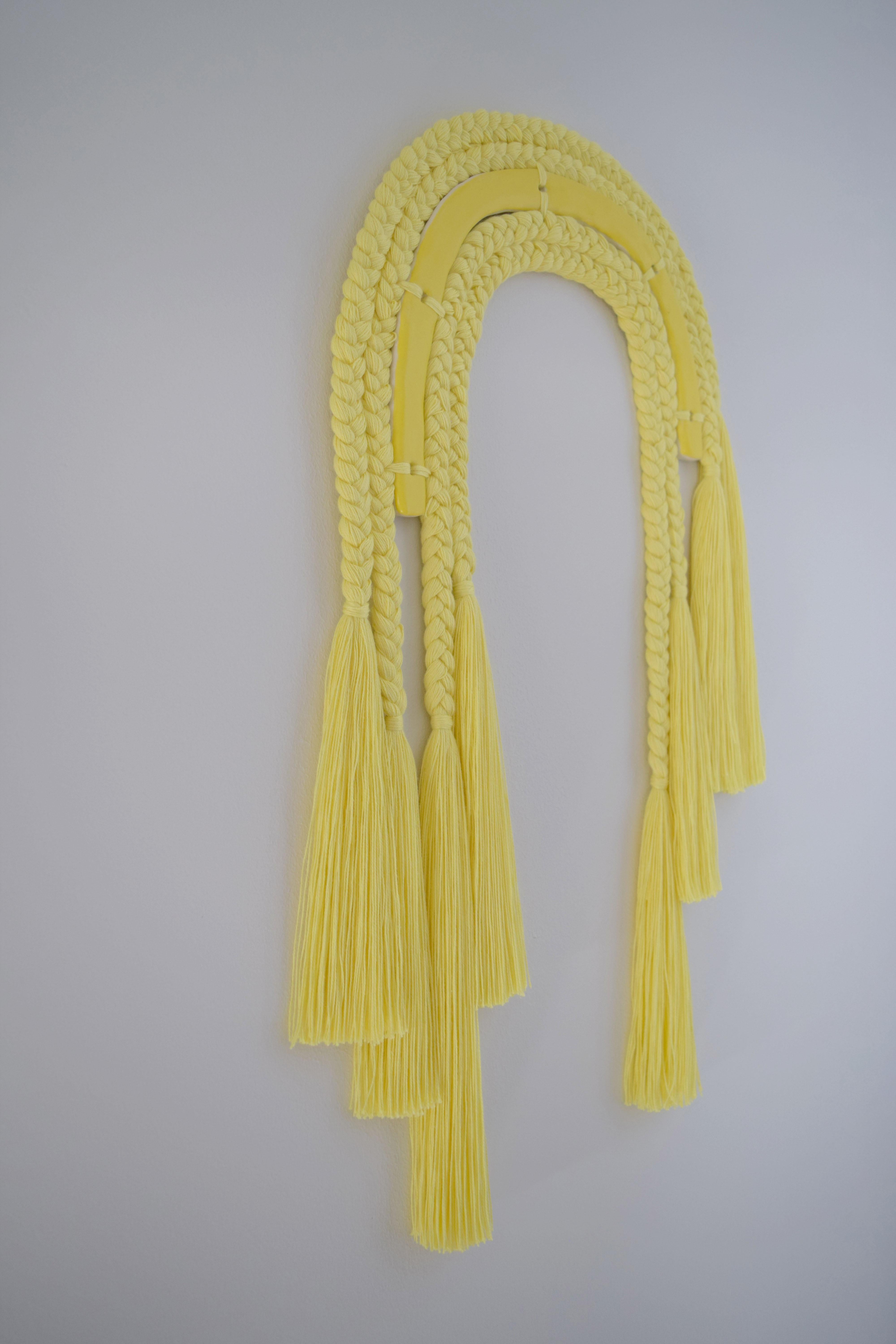 One of a kind wall sculpture #543

One of a kind wall sculpture in mixed materials of ceramic and braided cotton fibers. A ceramic core, glazed in satin yellow is surrounded by braids in yellow cotton. Braids transition into varying lengths of