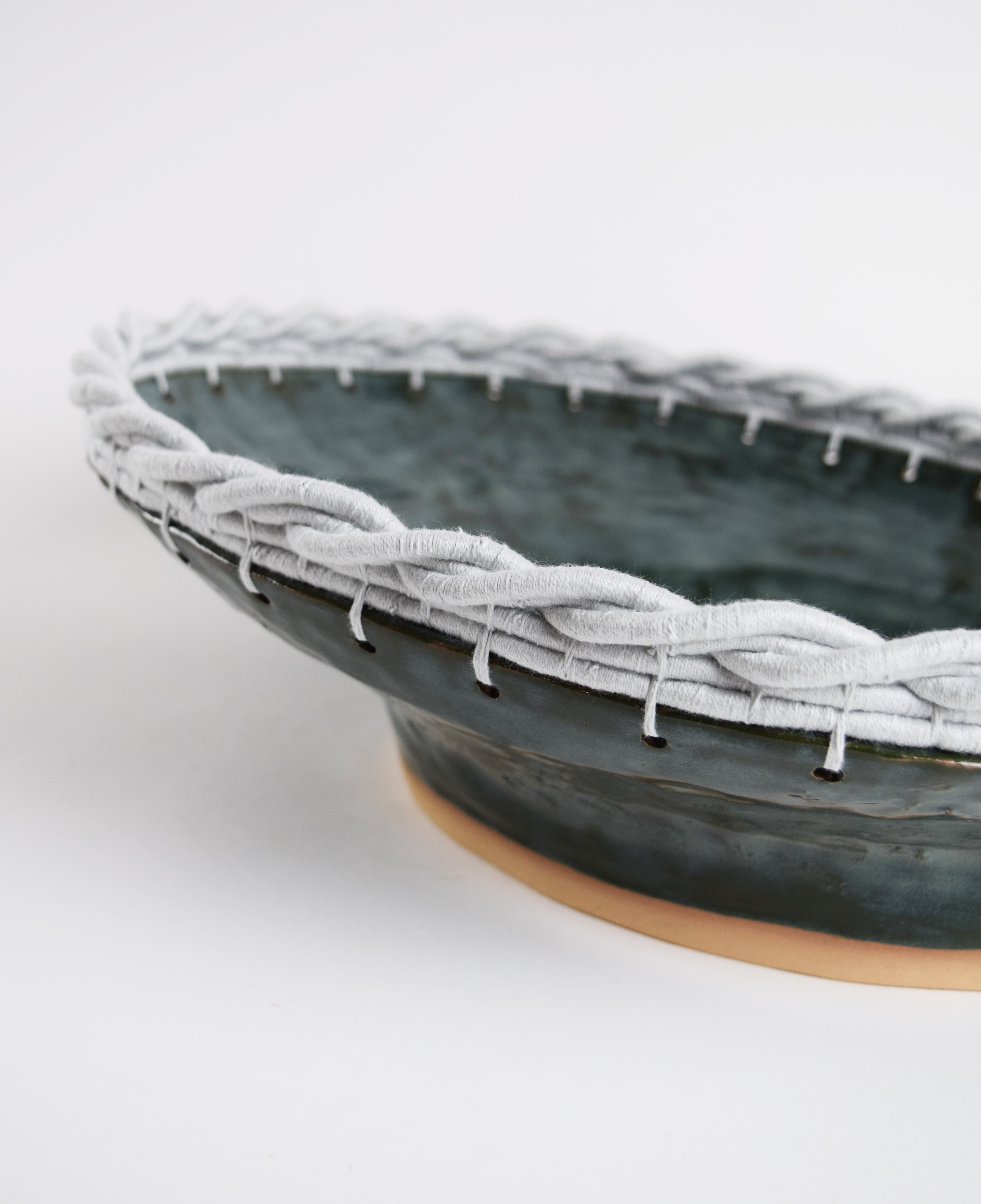 Decorative Bowl #830 by Karen Gayle Tinney

Hand formed stoneware bowl with shiny green-blue glaze. Woven pale blue cotton edge detail. For decorative use only.

16”W x 5.5”H x 14”D

One of a kind collections are released periodically throughout the
