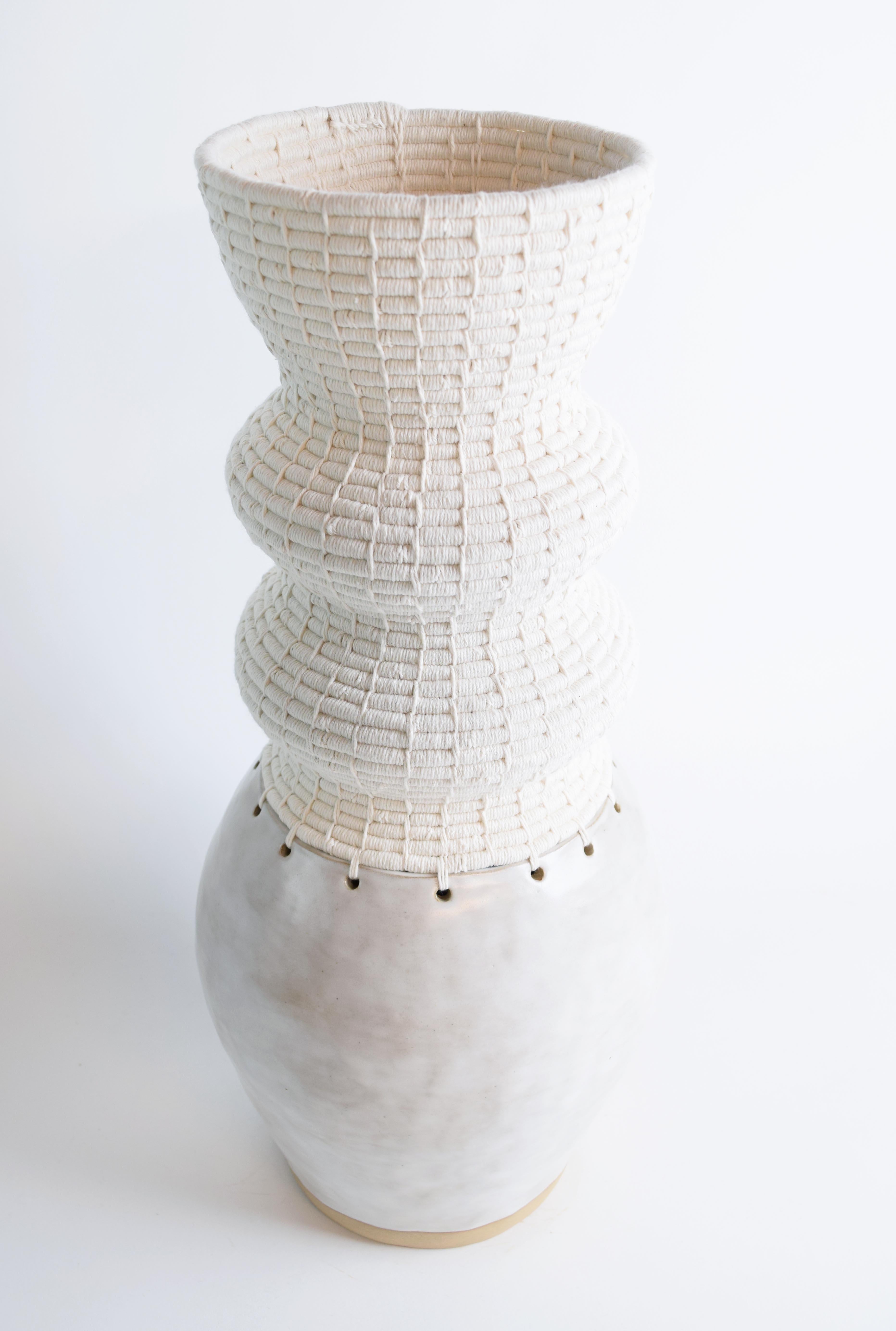 Vessel #813 by Karen Gayle Tinney

Hand formed stoneware base with satin white glaze. The top part is woven in white cotton.

20”H x 8”W

One of a kind collections with a limited number of pieces are released periodically throughout the year. Each
