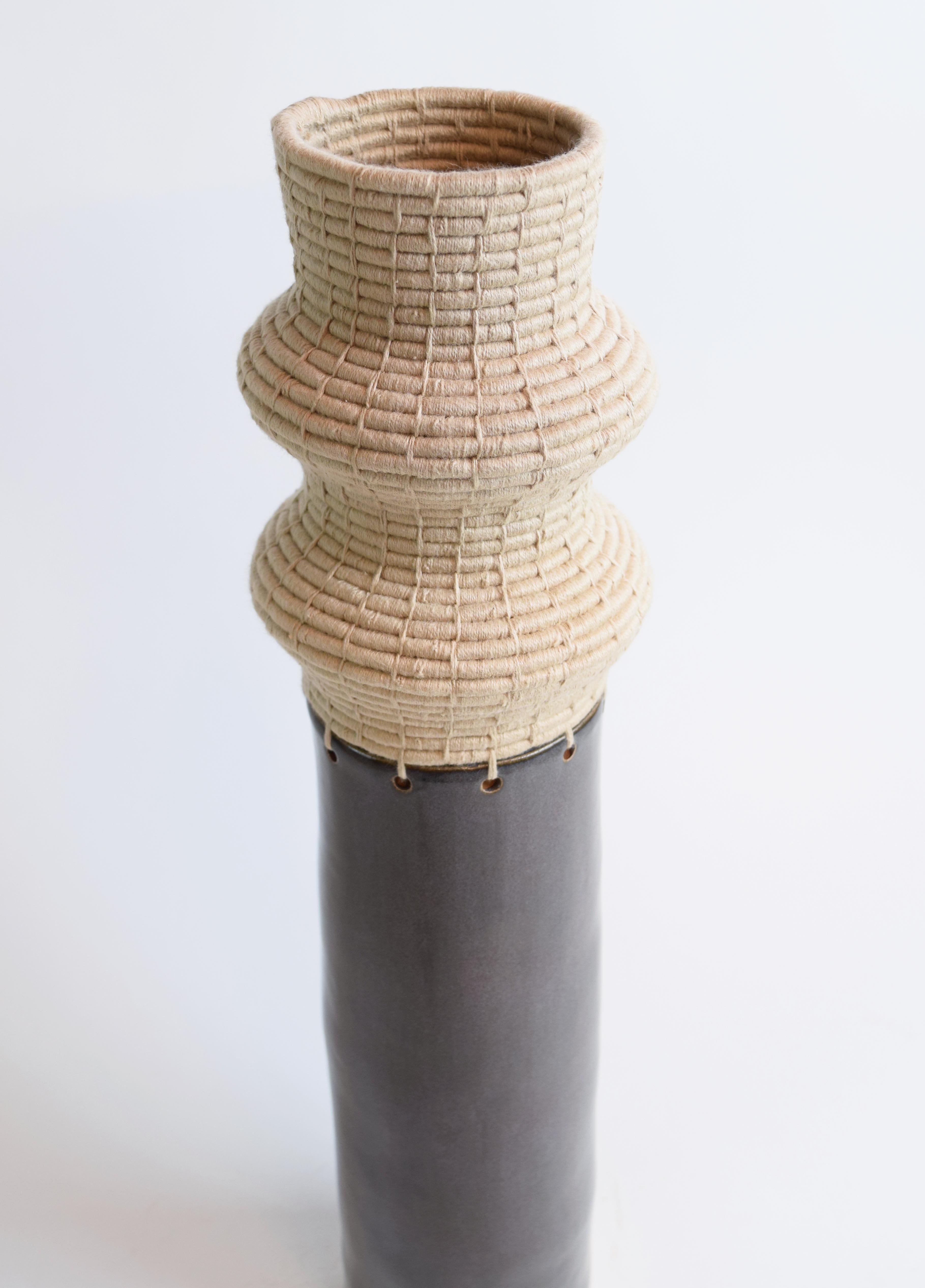 Vessel #814 by Karen Gayle Tinney

Hand formed stoneware base with satin charcoal glaze. The top part is woven in tan cotton.

21.25”H x 4”W

One of a kind collections with a limited number of pieces are released periodically throughout the year.