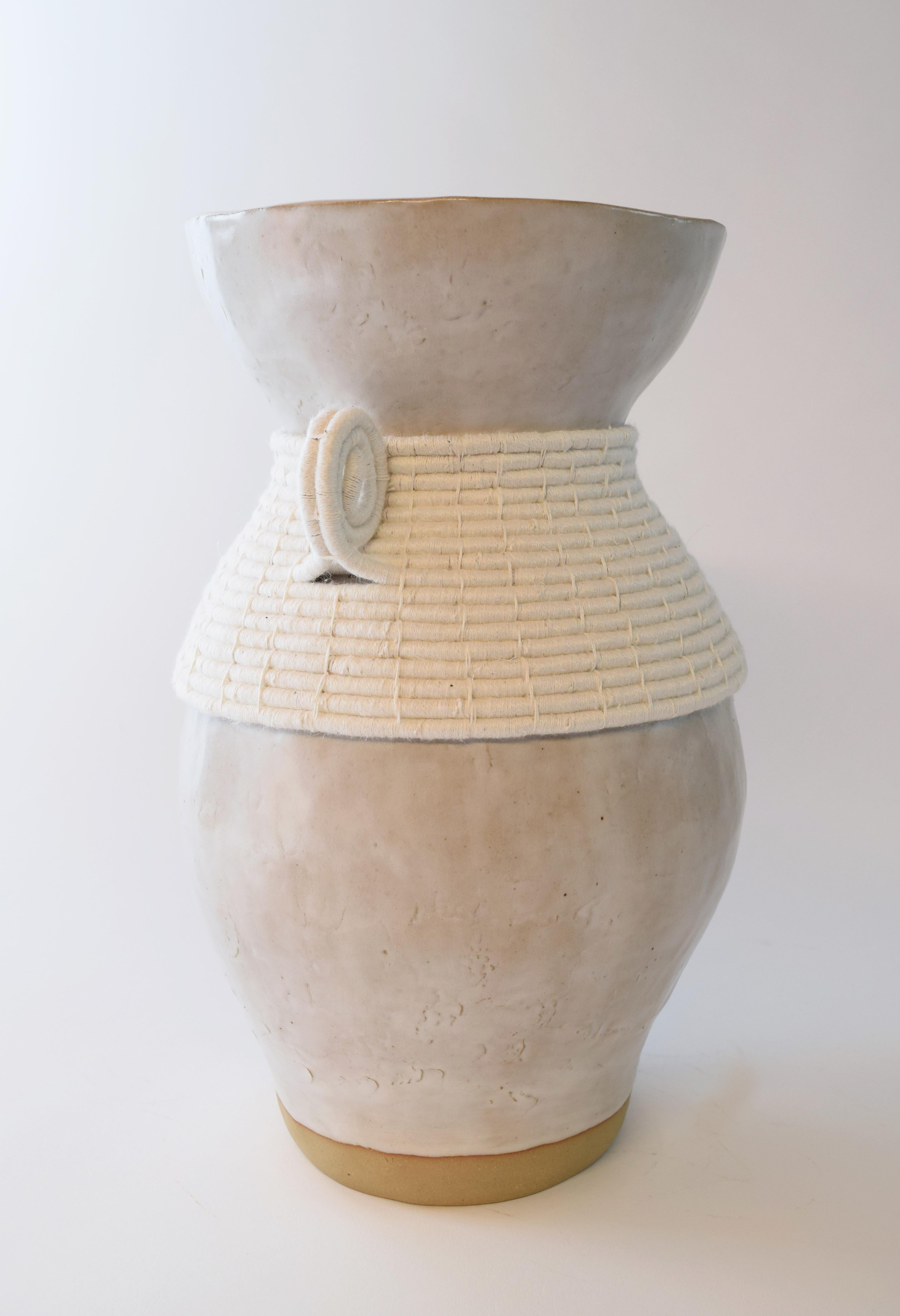Vase #766 by Karen Gayle Tinney

Hand formed stoneware vase with white satin glaze. Woven white cotton detailing around outside of vessel. Vase is water tight.

13.5”H x 8”W

One of a kind collections are released periodically throughout the year.