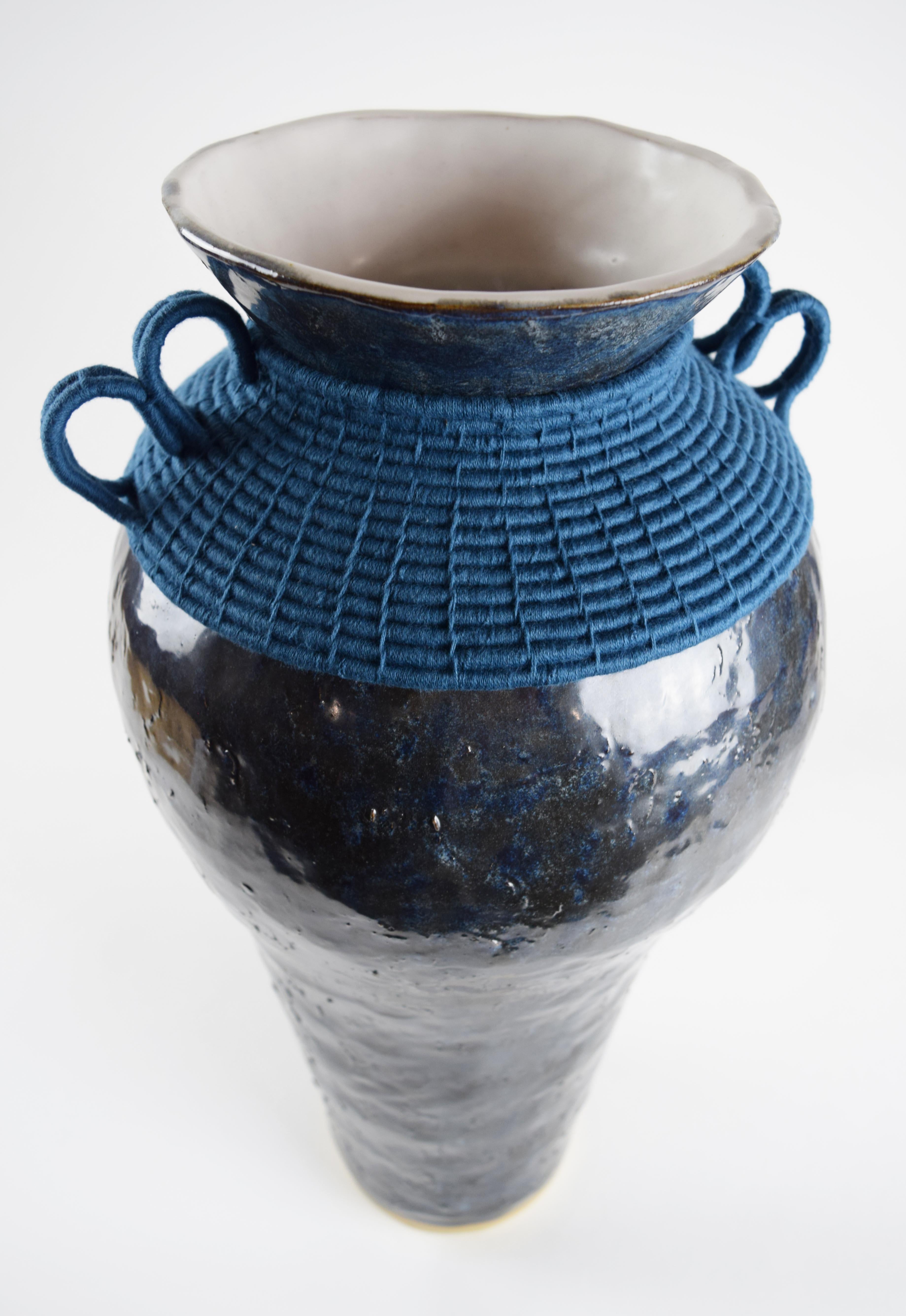 One of a kind Vase #833 by Karen Gayle Tinney

Hand formed stoneware vase with dark gray-blue glaze. Woven blue cotton detailing around the outside. Vase is water tight.

21”H x 9.5”W

One of a kind collections are released periodically throughout