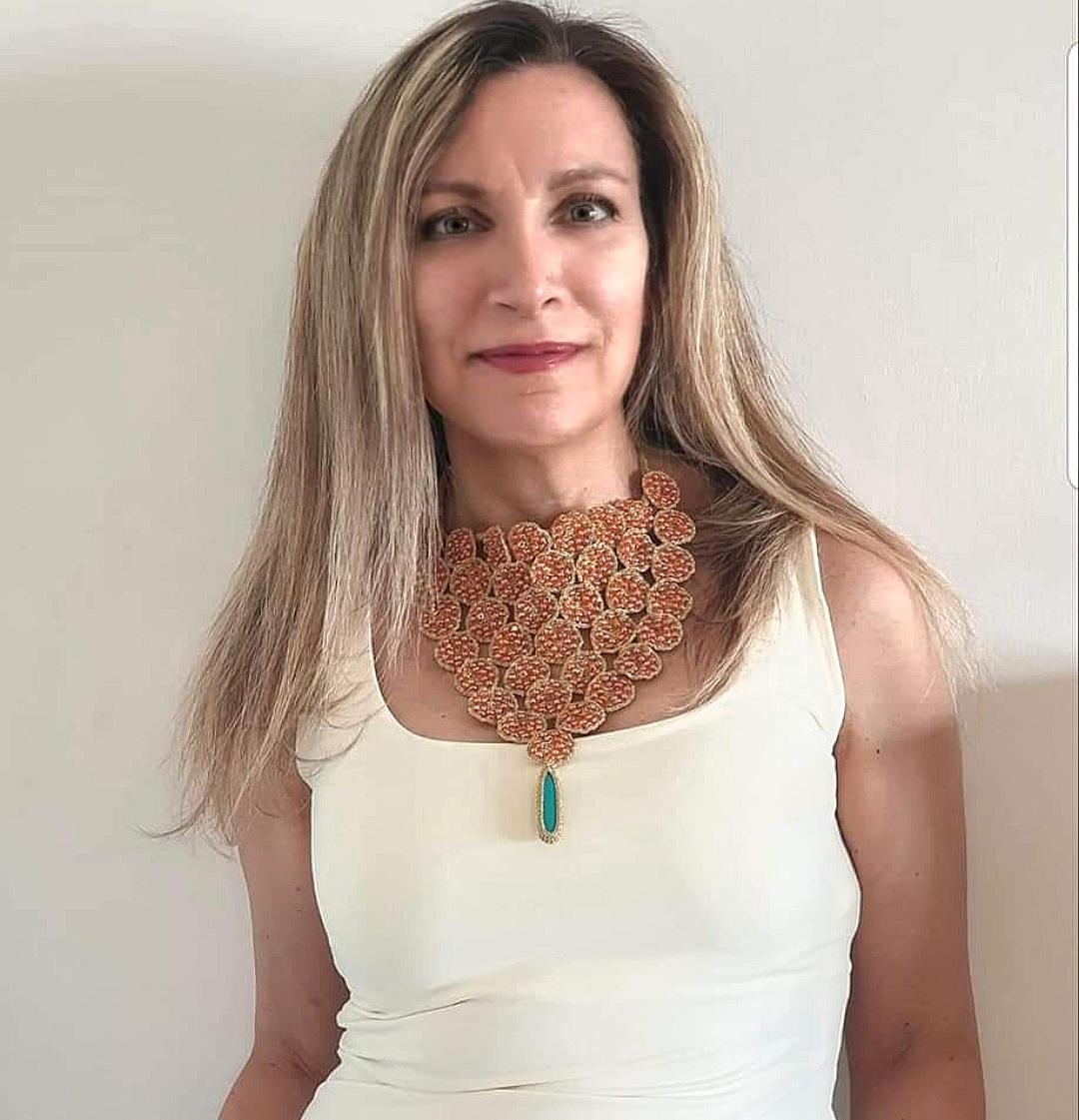 One of a kind hand crochet summery Necklace. This necklace is made out of circular patterns with Orange Glass Beads and a Howlite stone. It is a conversation starter. A statement Necklace. Bold and young. Golden smooth passing thread with no metal