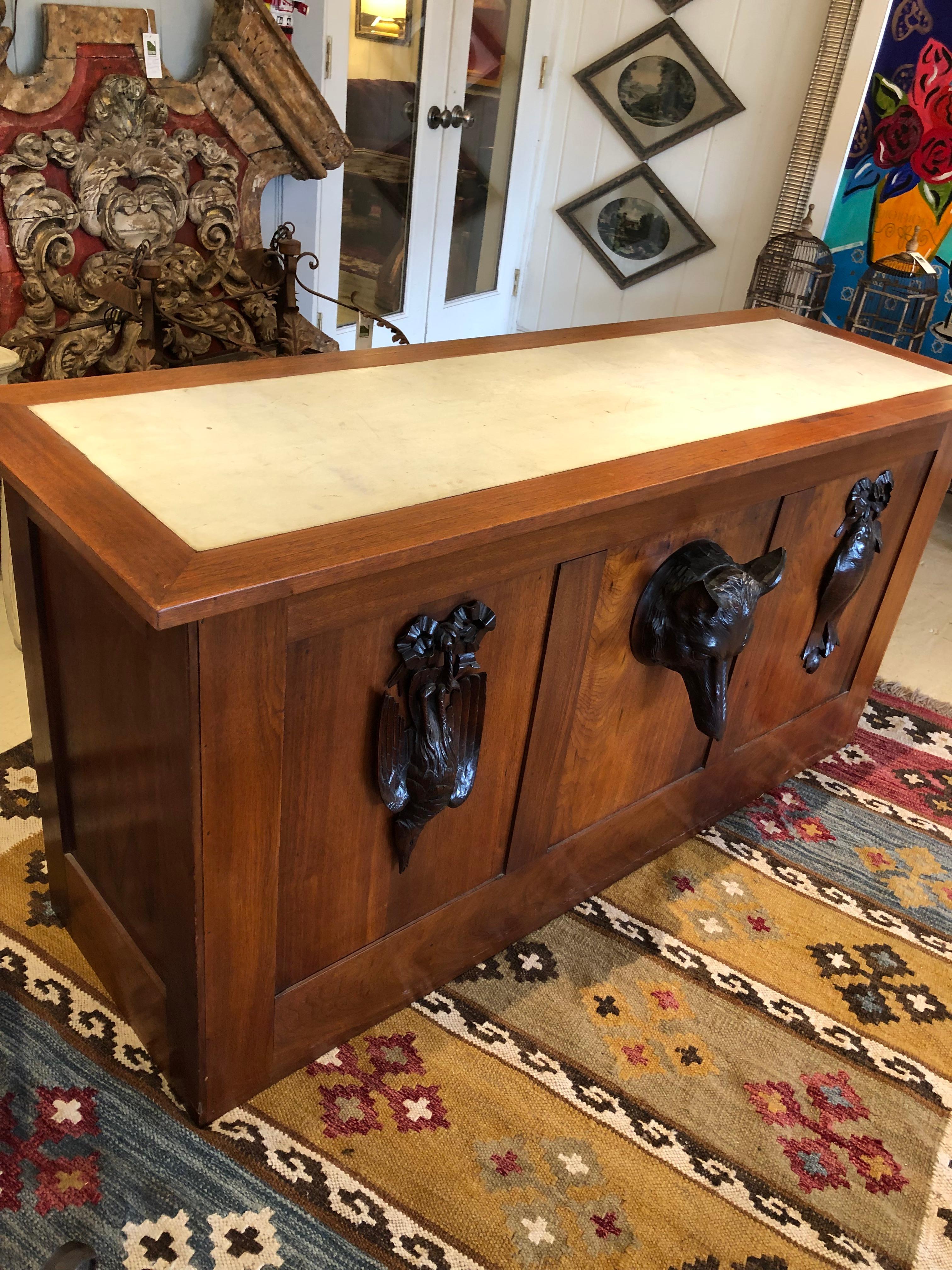 Extraordinary custom desk made of aged honey oak having two large drawers on each side with 3 smaller drawers in the top.  The narrower drawers have decorative carvings with oak leaves and branches.  The dark matte brass hardware complements the