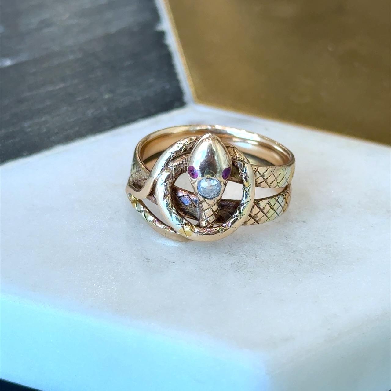 Unique Antique Victorian Ring 

.10CT Beautiful Old Mine Cut Diamond

Two Old Cut Ruby Eyes

Size 6.25 and it Can be Resized

The Top is 14mm Wide

Weight 5.4 grams 14kt Yellow, White, and Rose Gold 

Why we love it: A gorgeous example of a snake