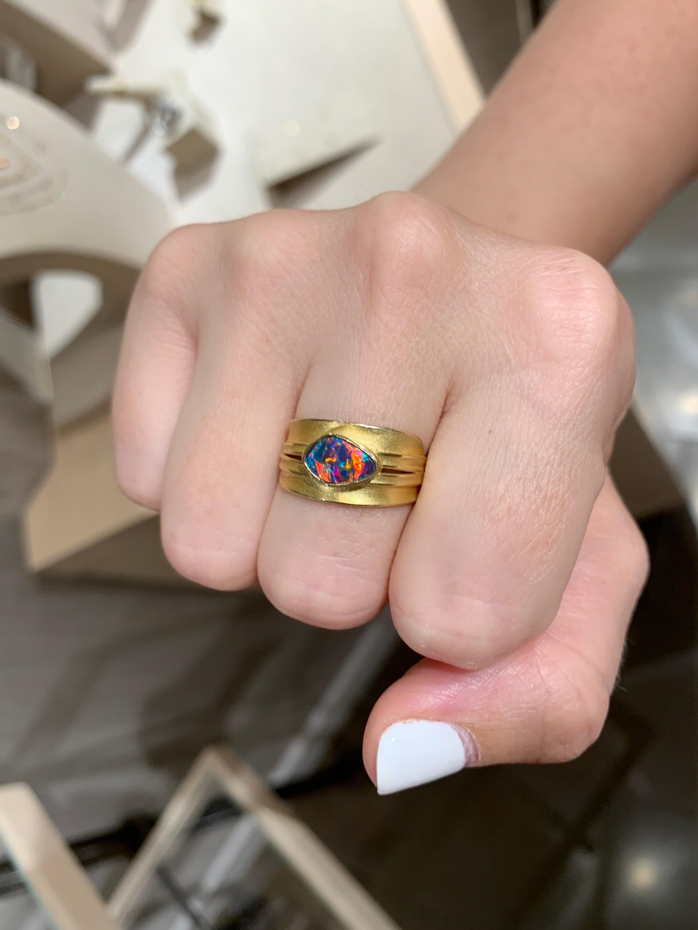 One of a Kind Ring hand-fabricated in matte and high-polished 18k yellow gold by award-winning jewelry designer Barbara Heinrich showcasing a stunning 0.68 carat irregular-shaped gem opal doublet with strong red fire and rainbow flash, bezel in