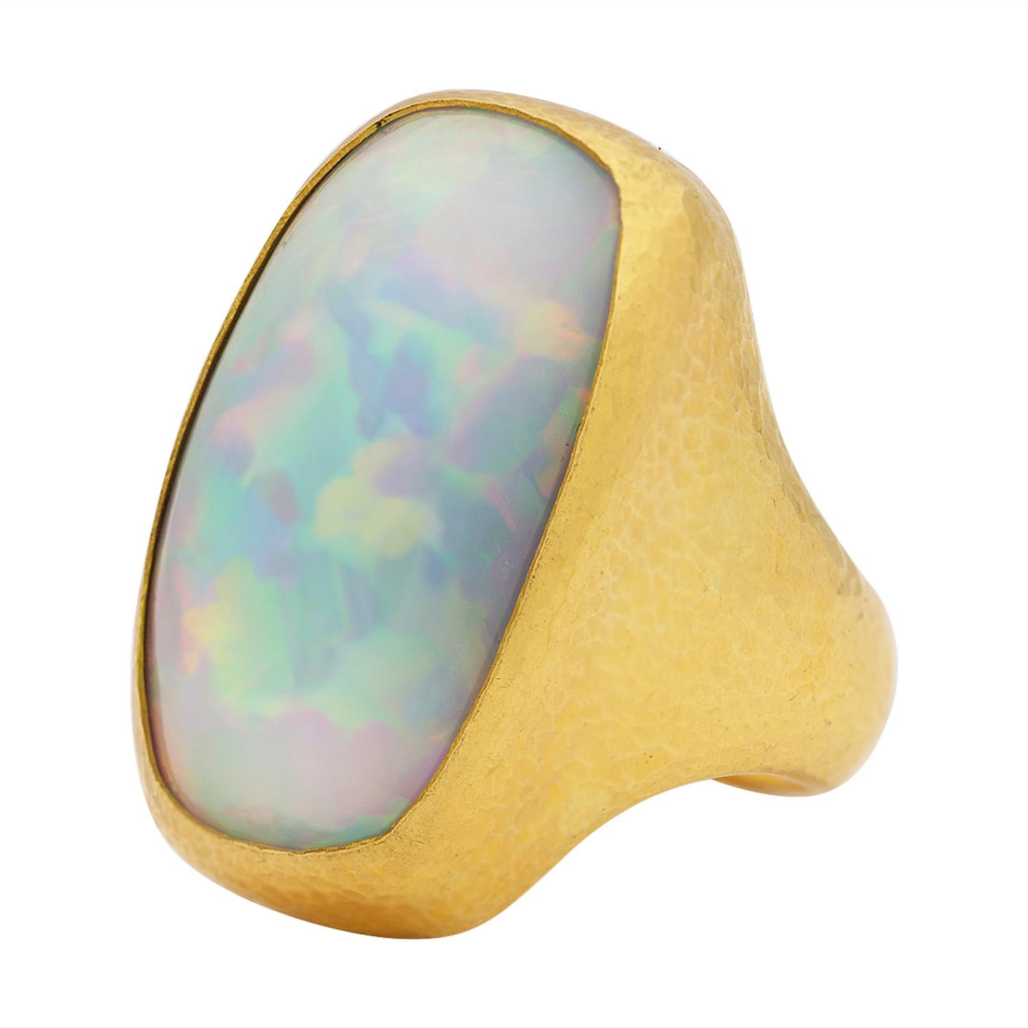 The one-of-a-kind Center Stone ring by Gurhan is a magnificent showcase of craftsmanship and rare beauty. This stunning piece features a large, 30x17mm rectangular cabochon Ethiopian Opal weighing 35.56 carats, set in a 24k gold bezel. The opal,