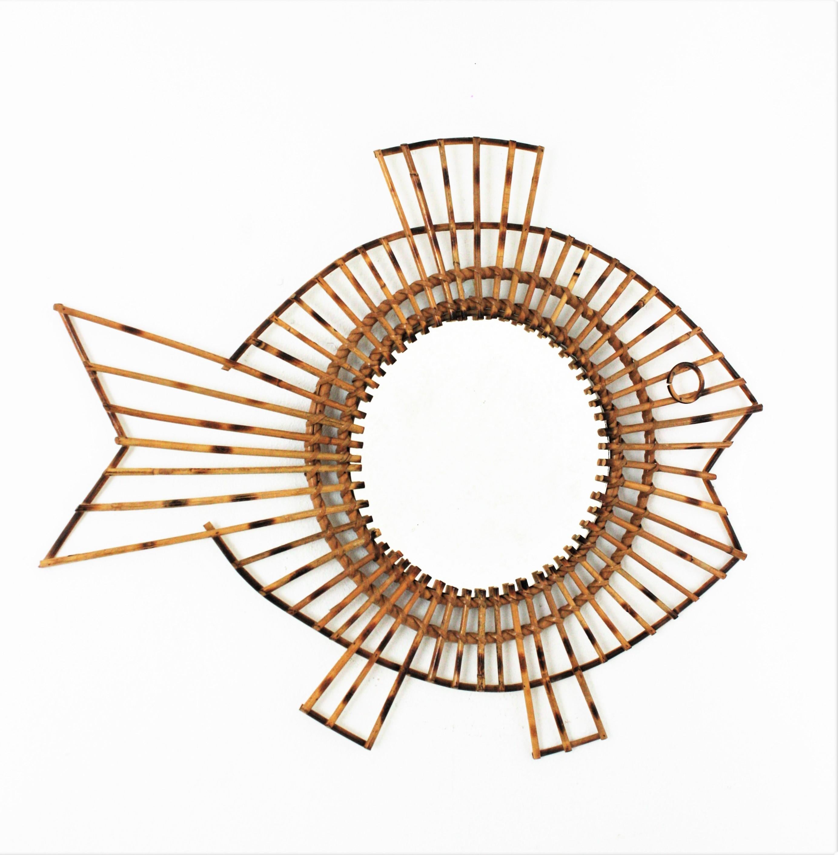 Unusual handcrafted rattan fish figure wall mirror, France, 1950s.
This spectacular mirror has a design combining the Midcentury taste from the French Riviera with oriental accents.
Excellent vintage condition.
Overall measures: 66 cm W x 55 cm H